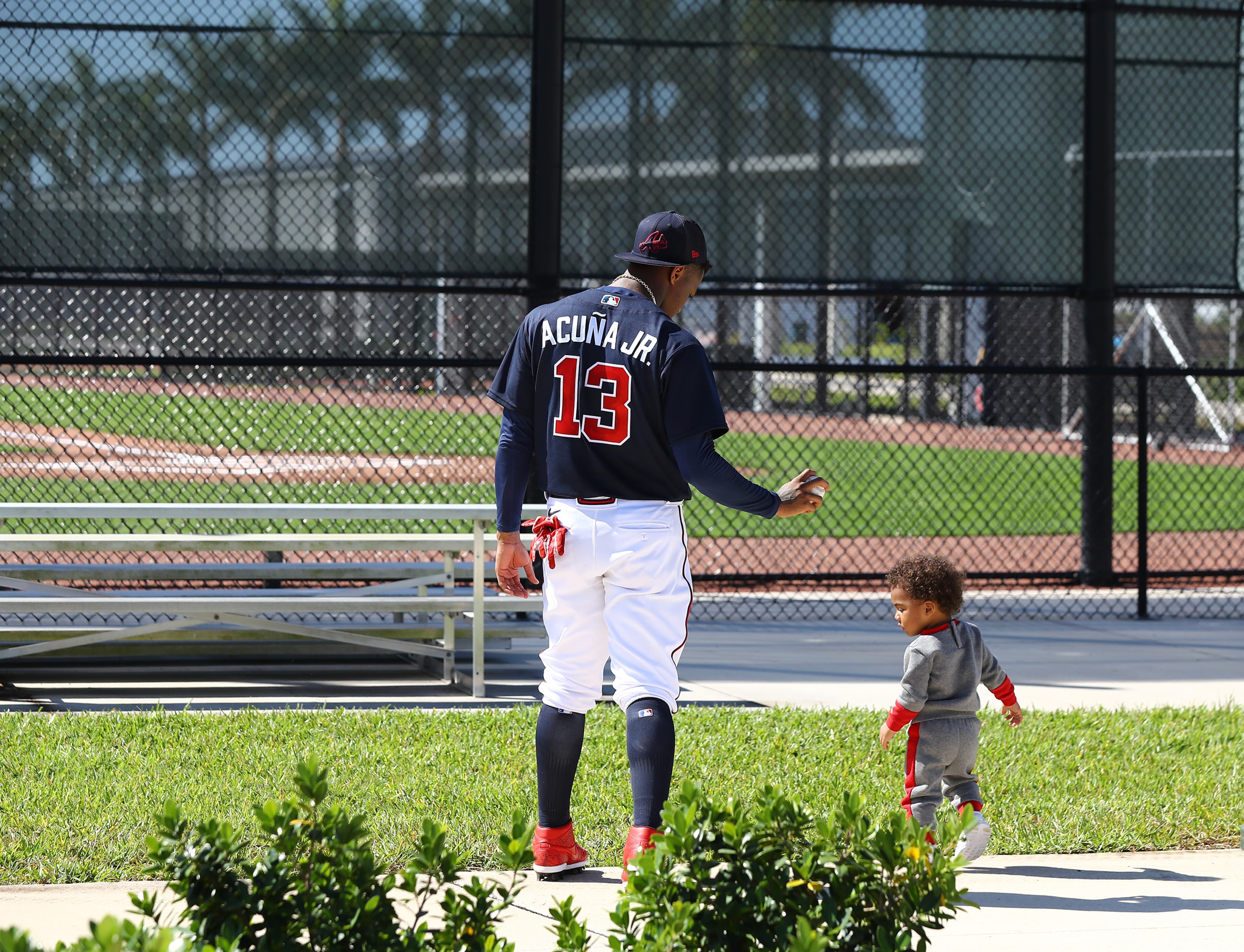 Braves outfielder Ronald Acuna gets in some father and son time with Ronald Acuna Jr. II after he finishes up batting practice during Spring Training on Thursday, March 17, 2022, in North Port. “Curtis Compton / Curtis.Compton@ajc.com”