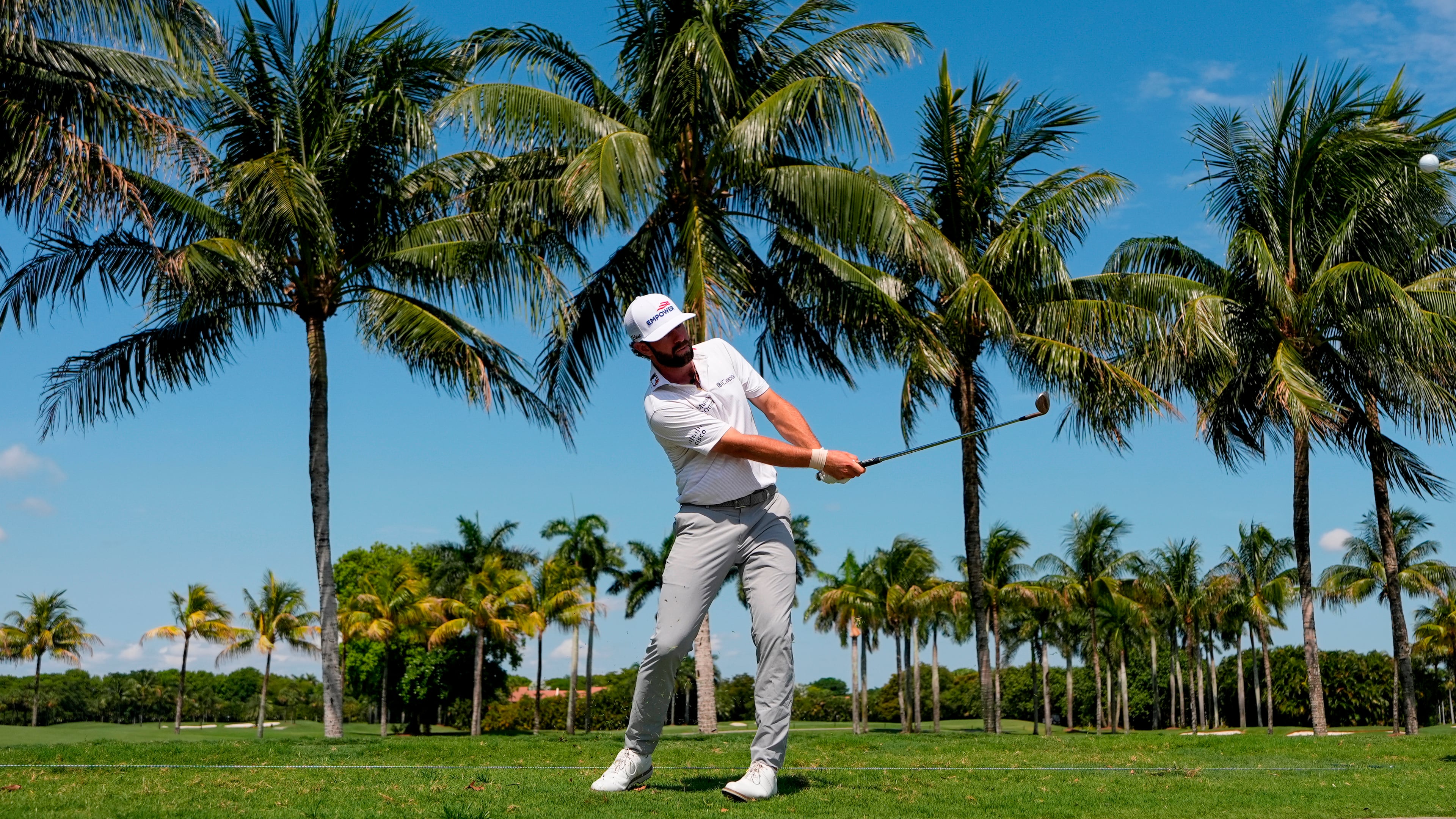 Cameron Young hits along the cart path on the first fairway during the first round of the Cadillac Championship PGA golf tournament Thursday, April 30, 2026, in Doral, Fla. (AP Photo/David J. Phillip)