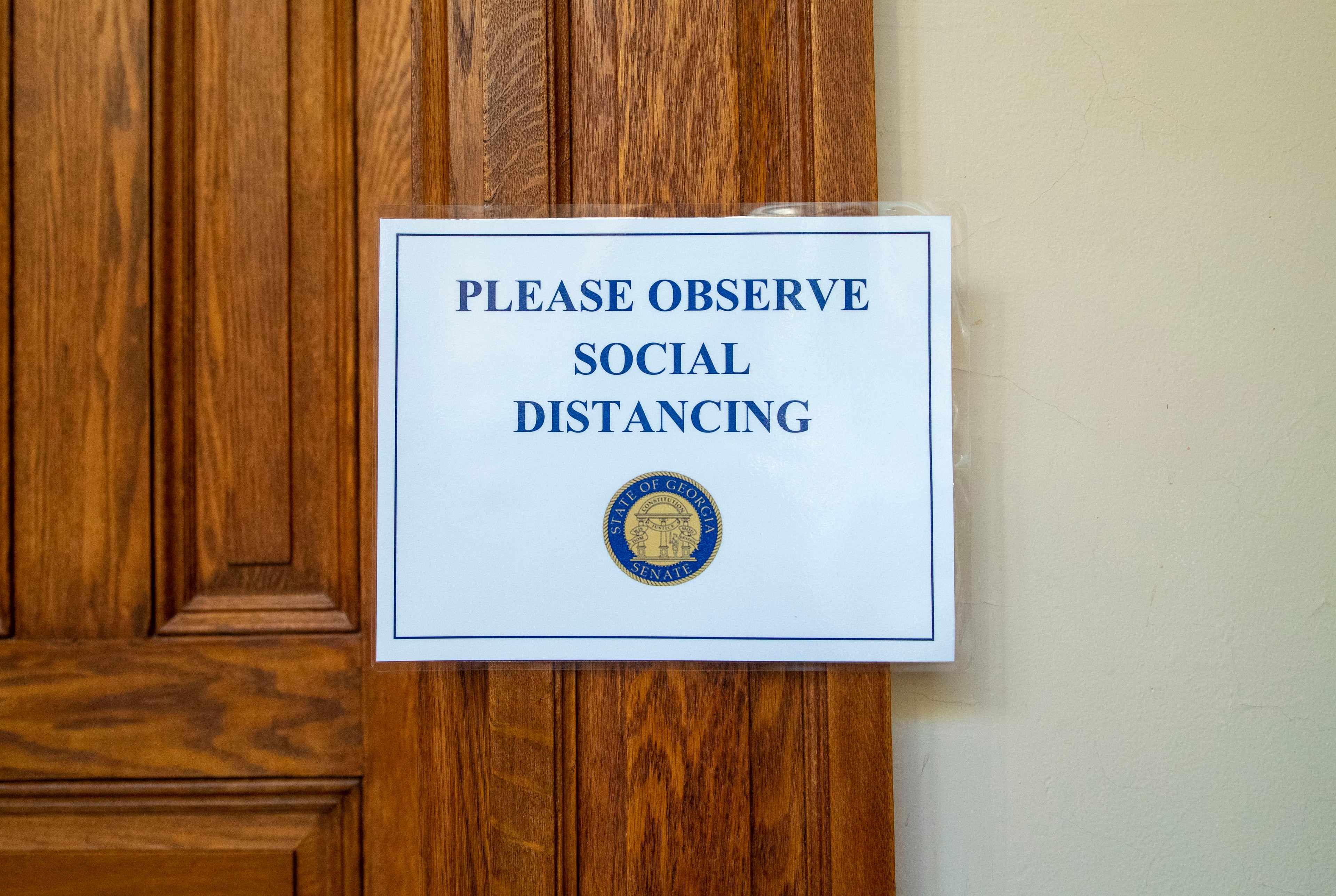 06/15/2020 - Atlanta , Georgia - A social distancing sign is displayed in the hallway of the Georgia State Capitol building on the 30th day of the legislative session in Atlanta, Monday, June 15, 2020. (ALYSSA POINTER / ALYSSA.POINTER@AJC.COM)
