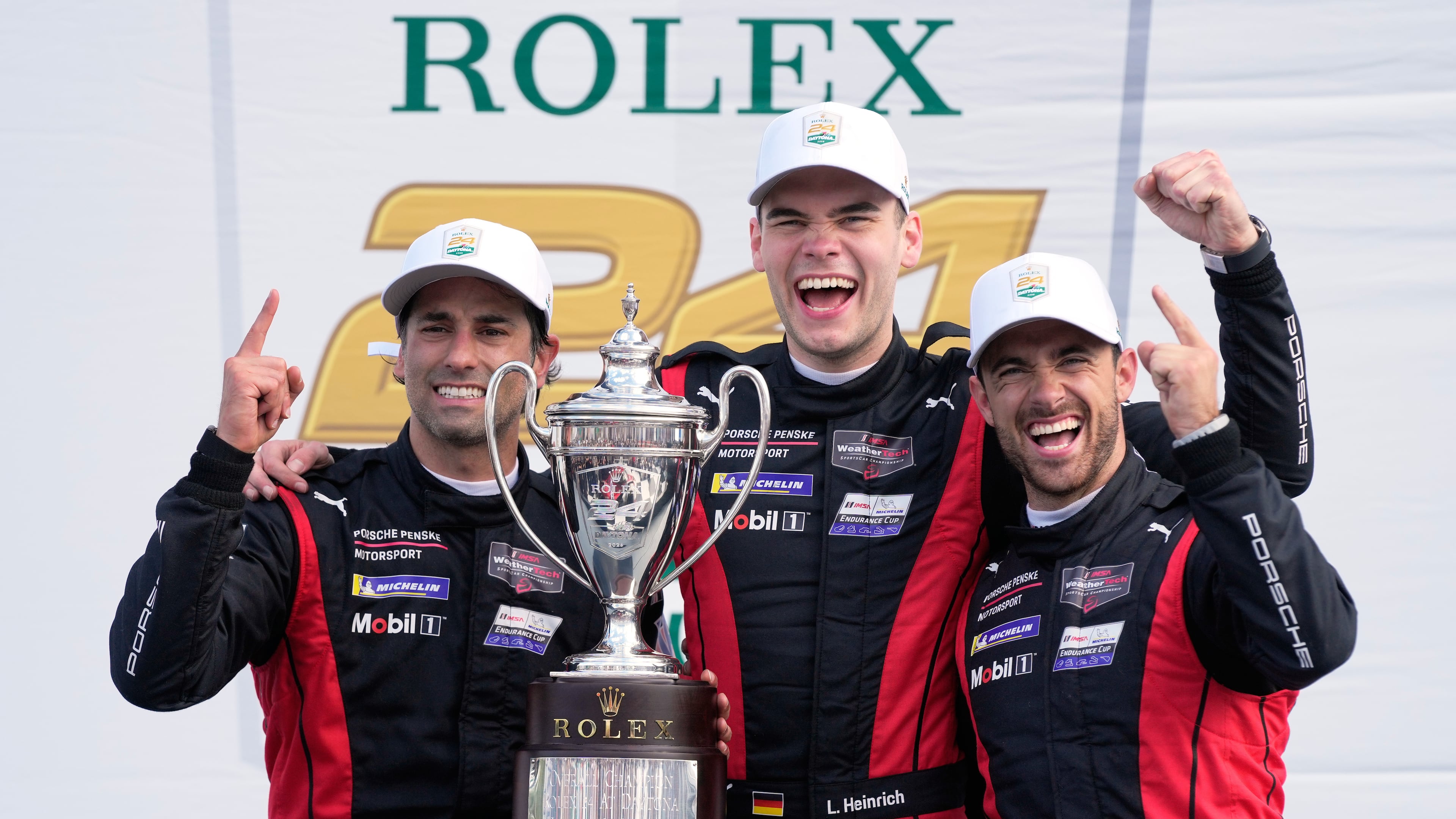 Winners of the Rolex 24 hour auto race, from left, Felipe Nasr, of Brazil, Laurin Heinrich, of Germany and Julien Andlauer, of France celebrate with the championship trophy in Victory Lane at Daytona International Speedway, Sunday, Jan. 25, 2026, in Daytona Beach, Fla. (AP Photo/John Raoux)