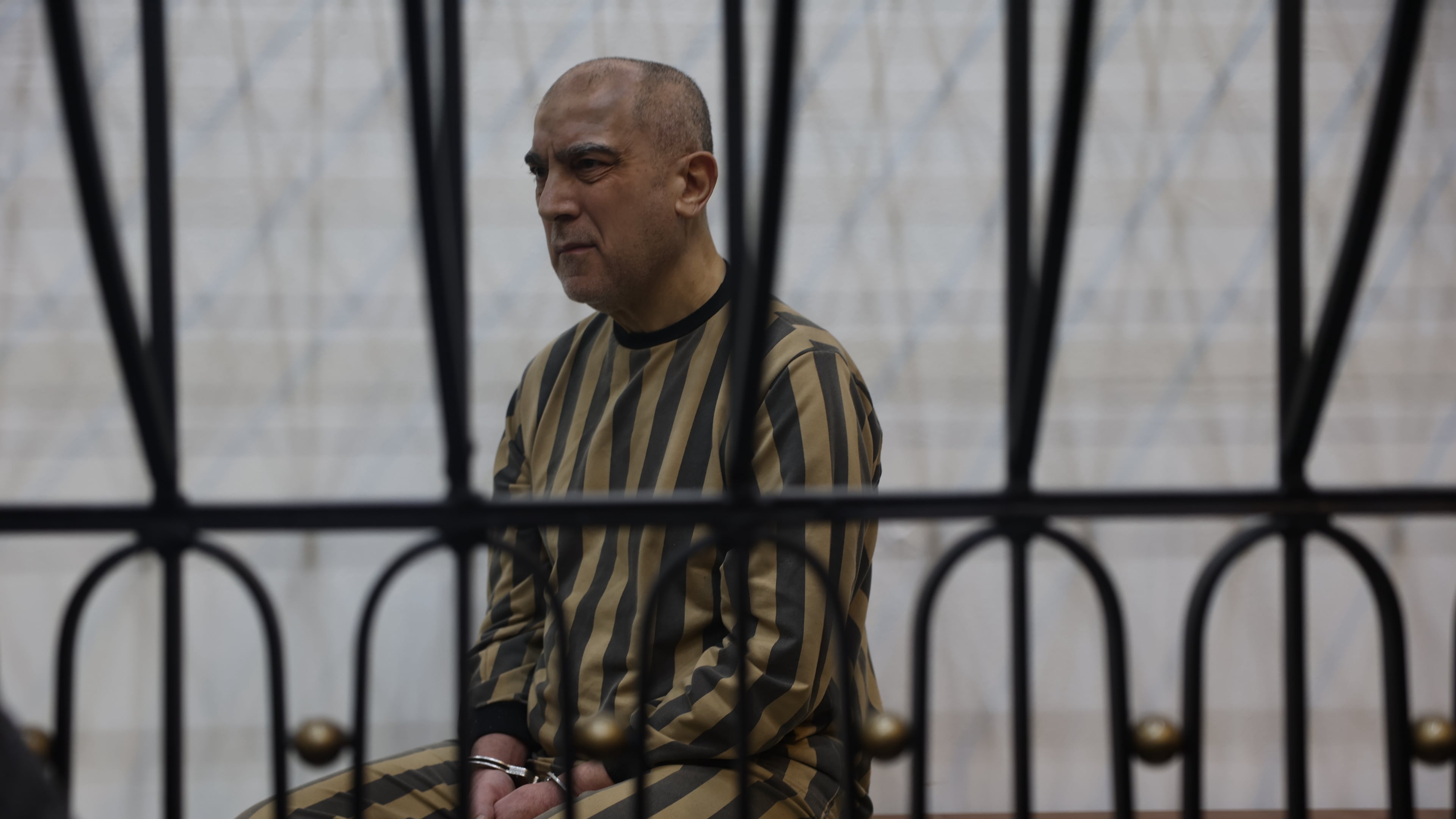 Atef Najib, former head of the Political Security Branch in the Daraa area during Bashar Assad's rule, sits in the defendants' cage during a trial session at the Palace of Justice in Damascus, Syria, Sunday, April 26, 2026. (AP Photo/Ghaith Alsayed)