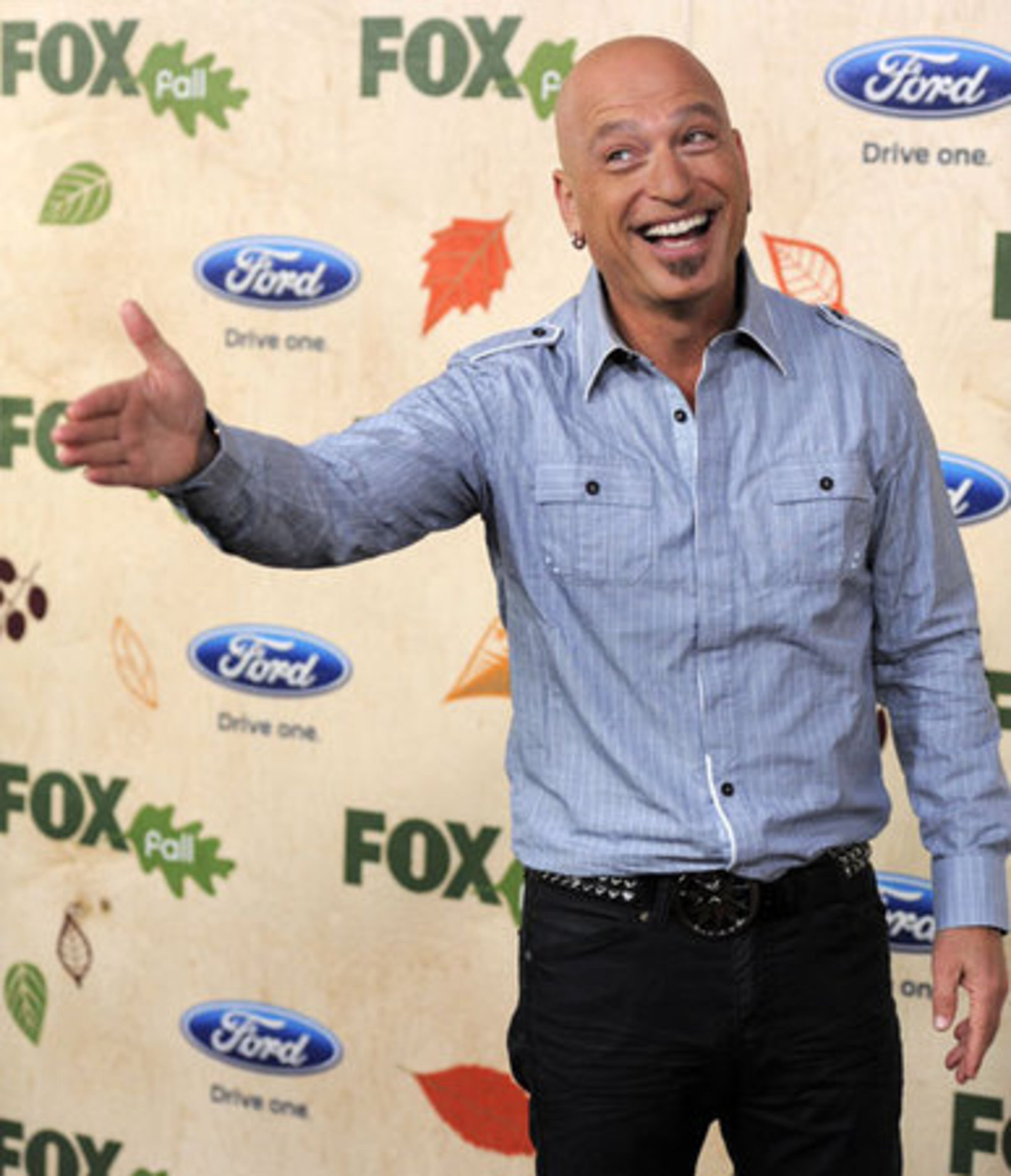 Howie Mandel, a cast member in the television series "Mobbed," reacts to photographers.