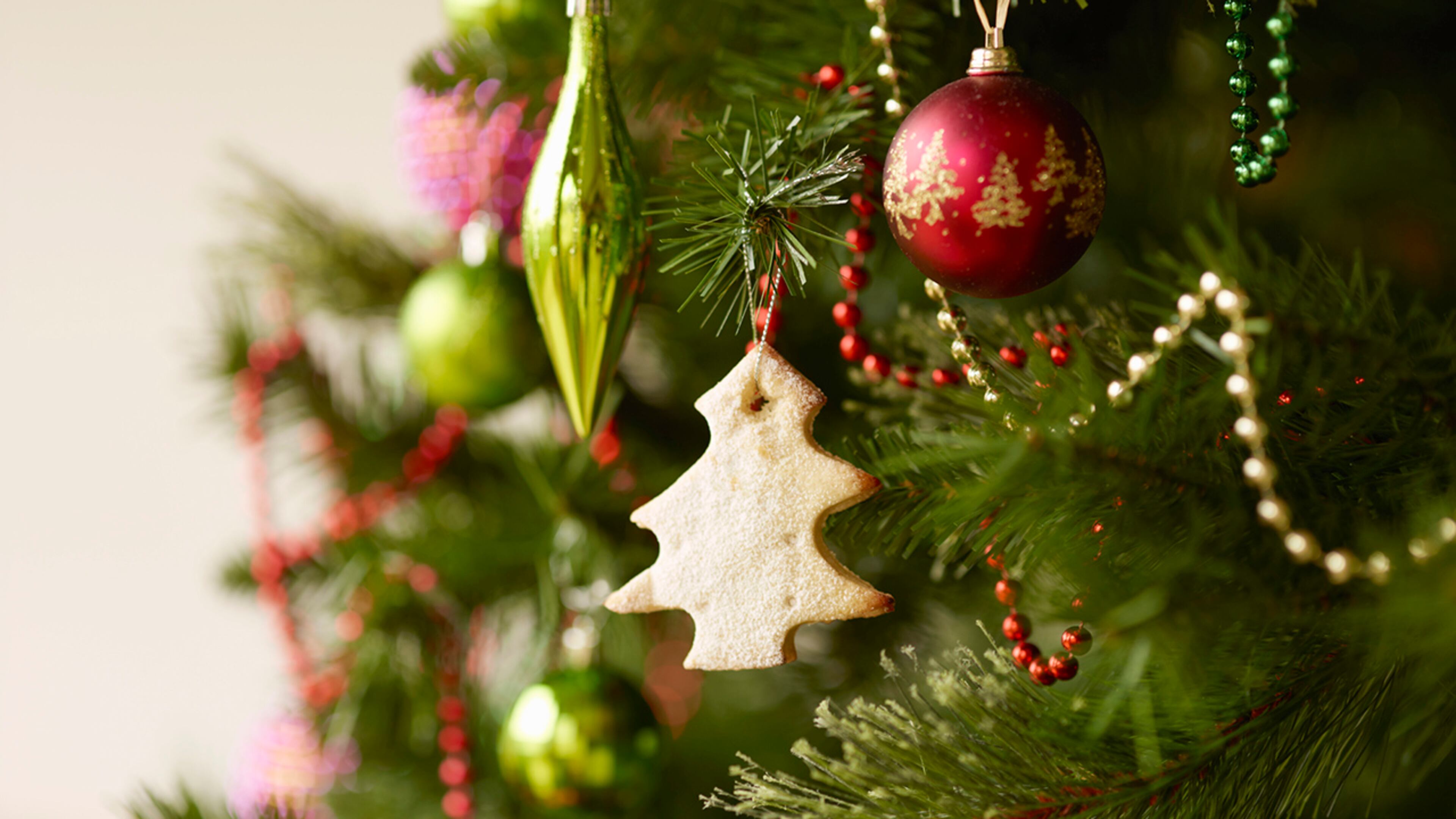 Close up of christmas tree with baubles and christmas biscuits