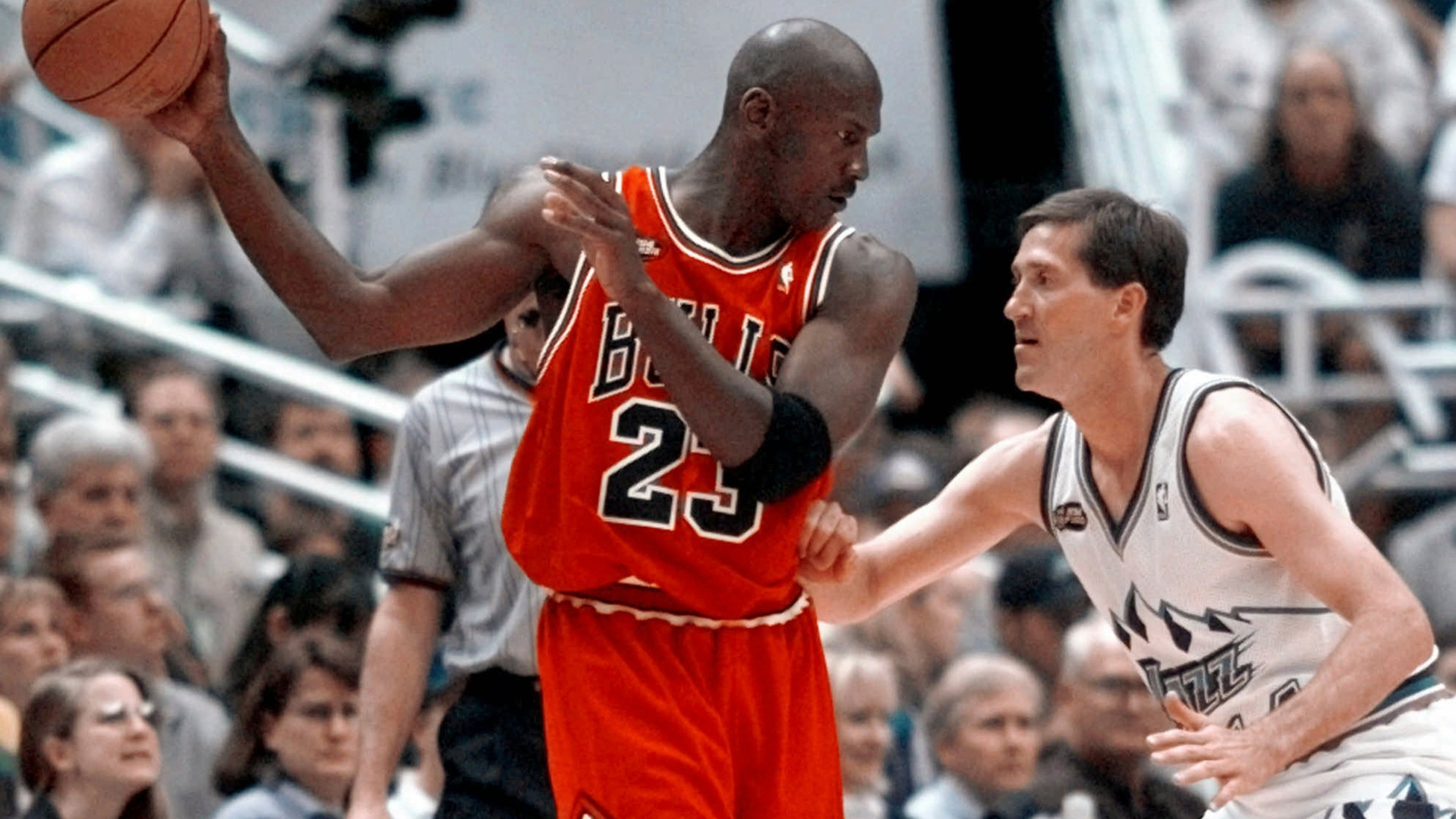 FILE - Chicago Bulls' Michael Jordan pulls the ball out of reach of Utah Jazz guard Jeff Hornacek during third quarter action in Game 2 of the NBA Finals in Salt Lake City, June 5, 1998. (AP Photo/Mark J. Terrill, file)