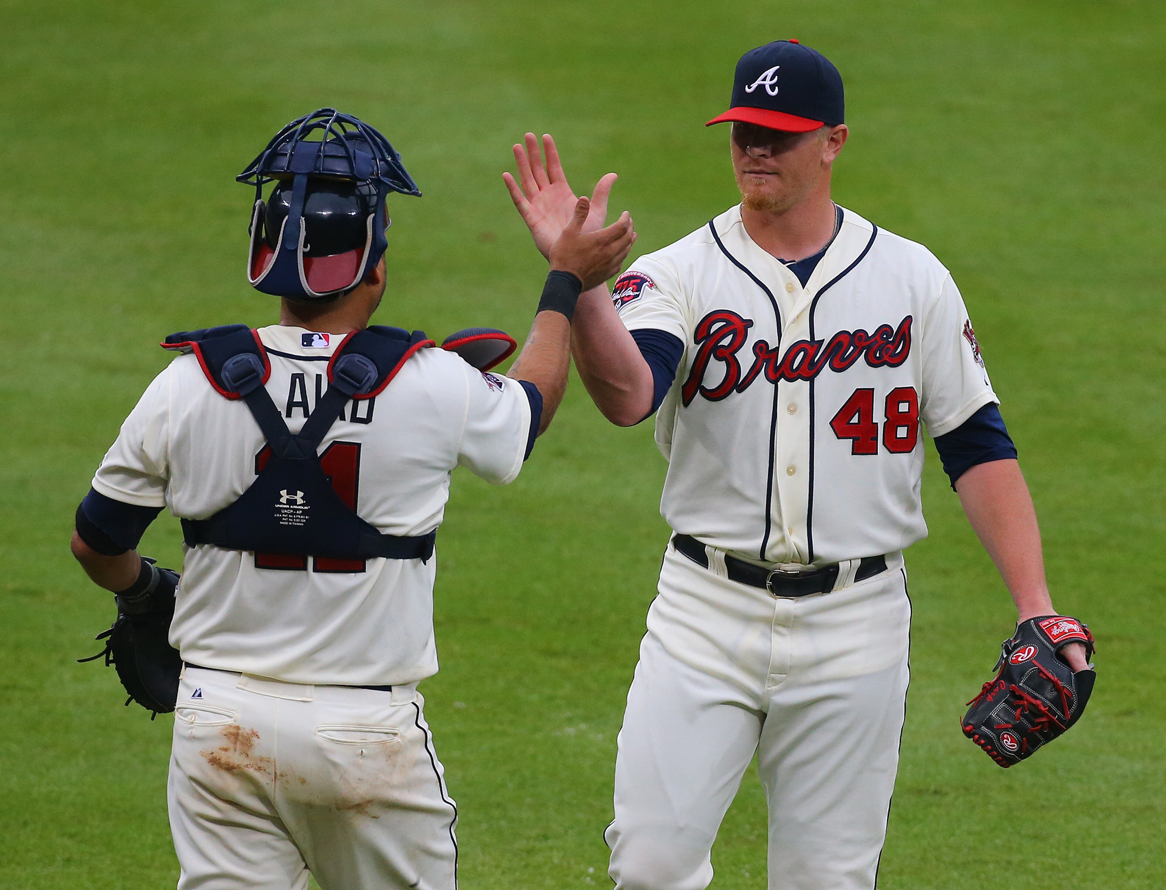 Braves Gerald Laird and closer David Carpenter celebrate a 8-2 victory over the Phillies in an MLB game on Sunday, July 20, 2014, in Atlanta. CURTIS COMPTON / CCOMPTON@AJC.COM