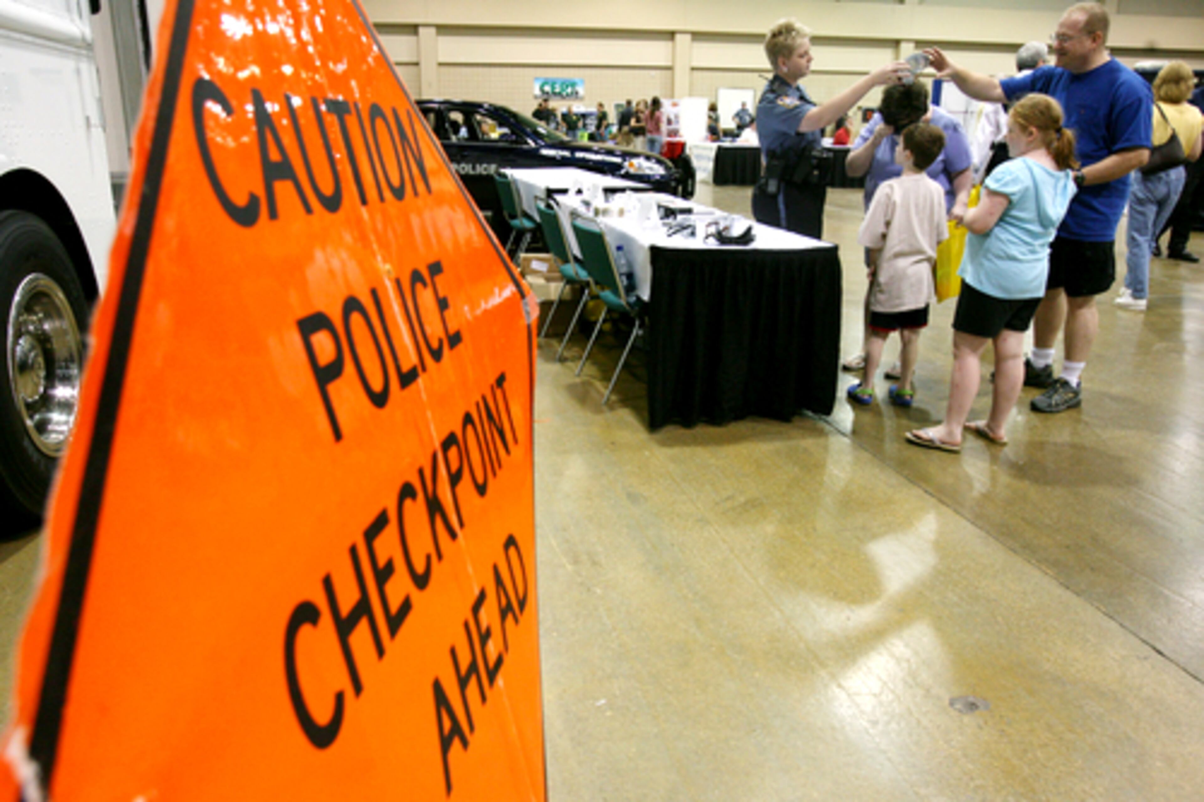 A portable sign advises visitors of a make-believe checkpoint as they stop at one of the exhibit stations.