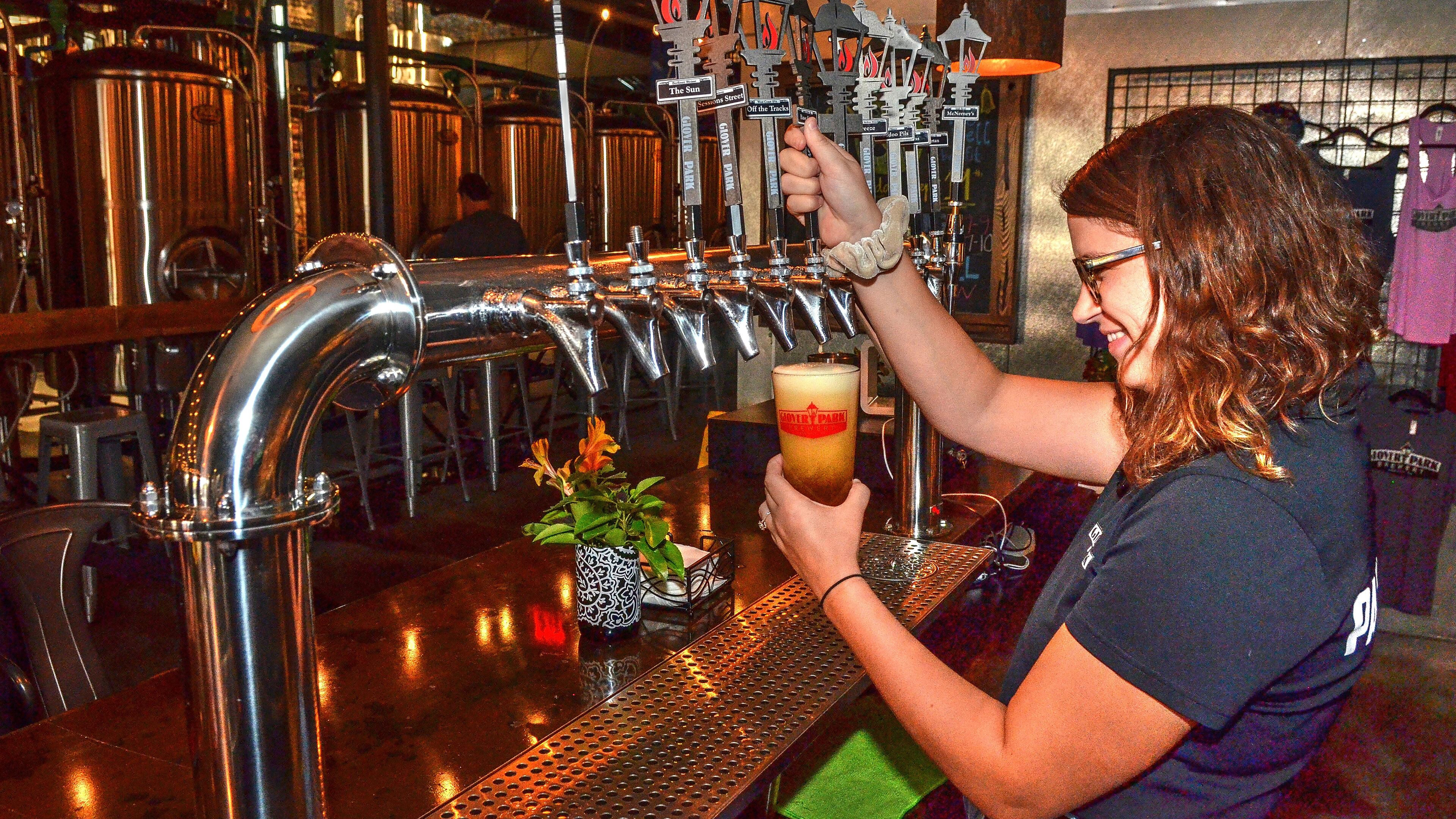Bartender Hayley Smalley pours a beer at Glover Park Brewery in Marietta. (Credit: Chris Hunt Photography)