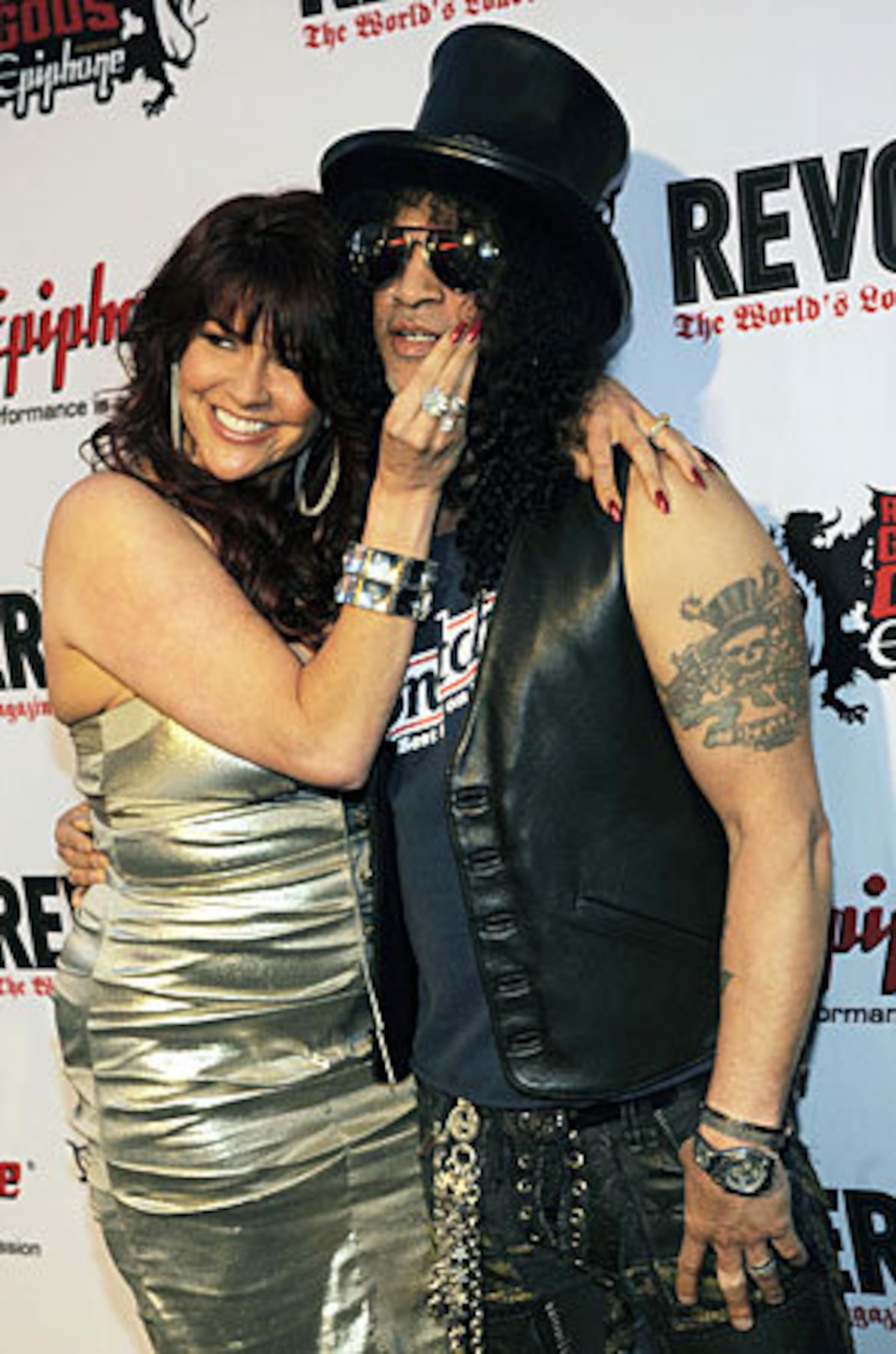 Guitarist Slash and his wife Perla arrive.