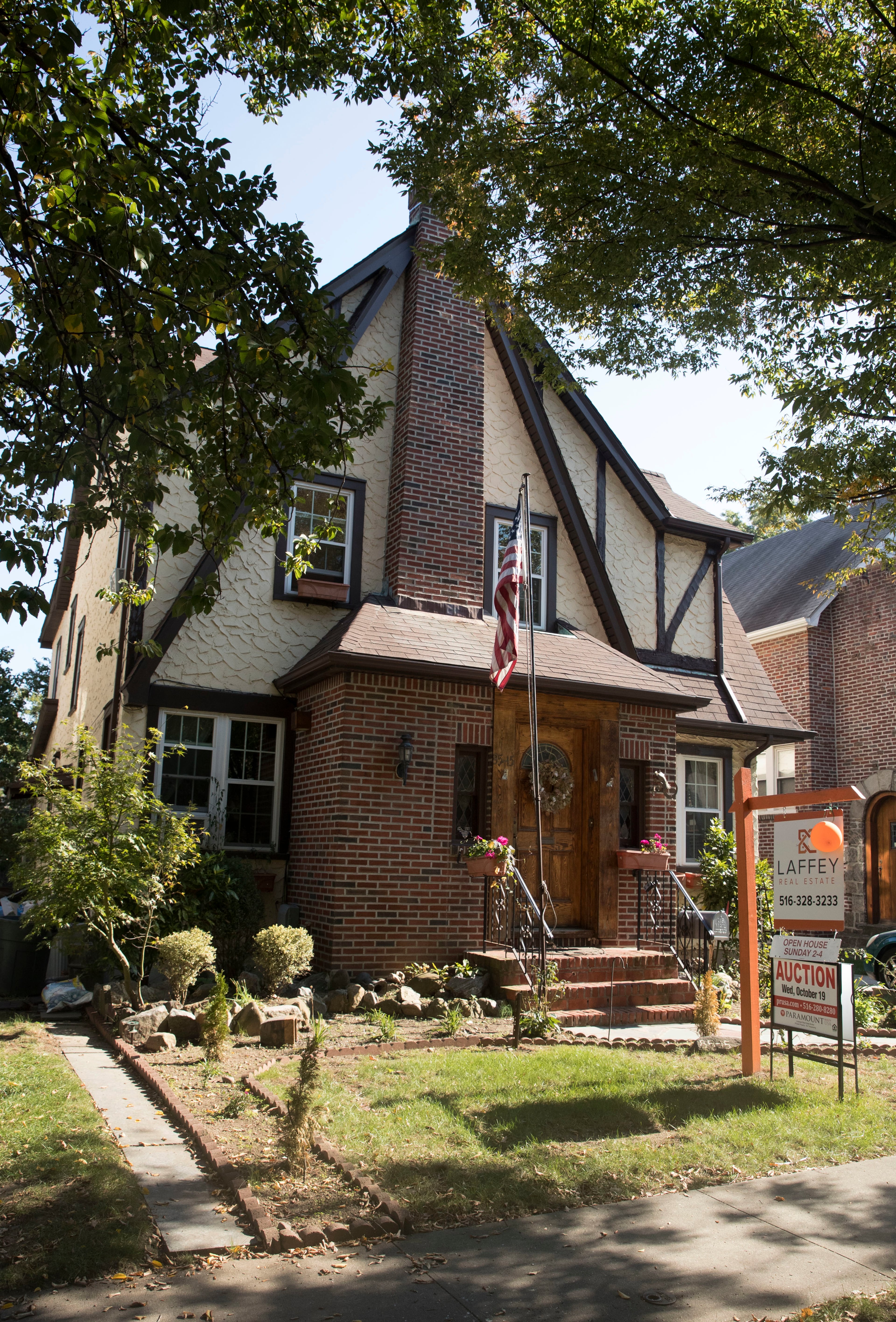 This Tuesday, Oct. 18, 2016 photo, shows the exterior of a house in the Jamaica Estates neighborhood of the Queens borough of New York, where Republican presidential candidate Donald Trump spent his early childhood. Trump's first boyhood home in New York City is going on the auction block with an opening bid of $849,000. (AP Photo/Mary Altaffer)