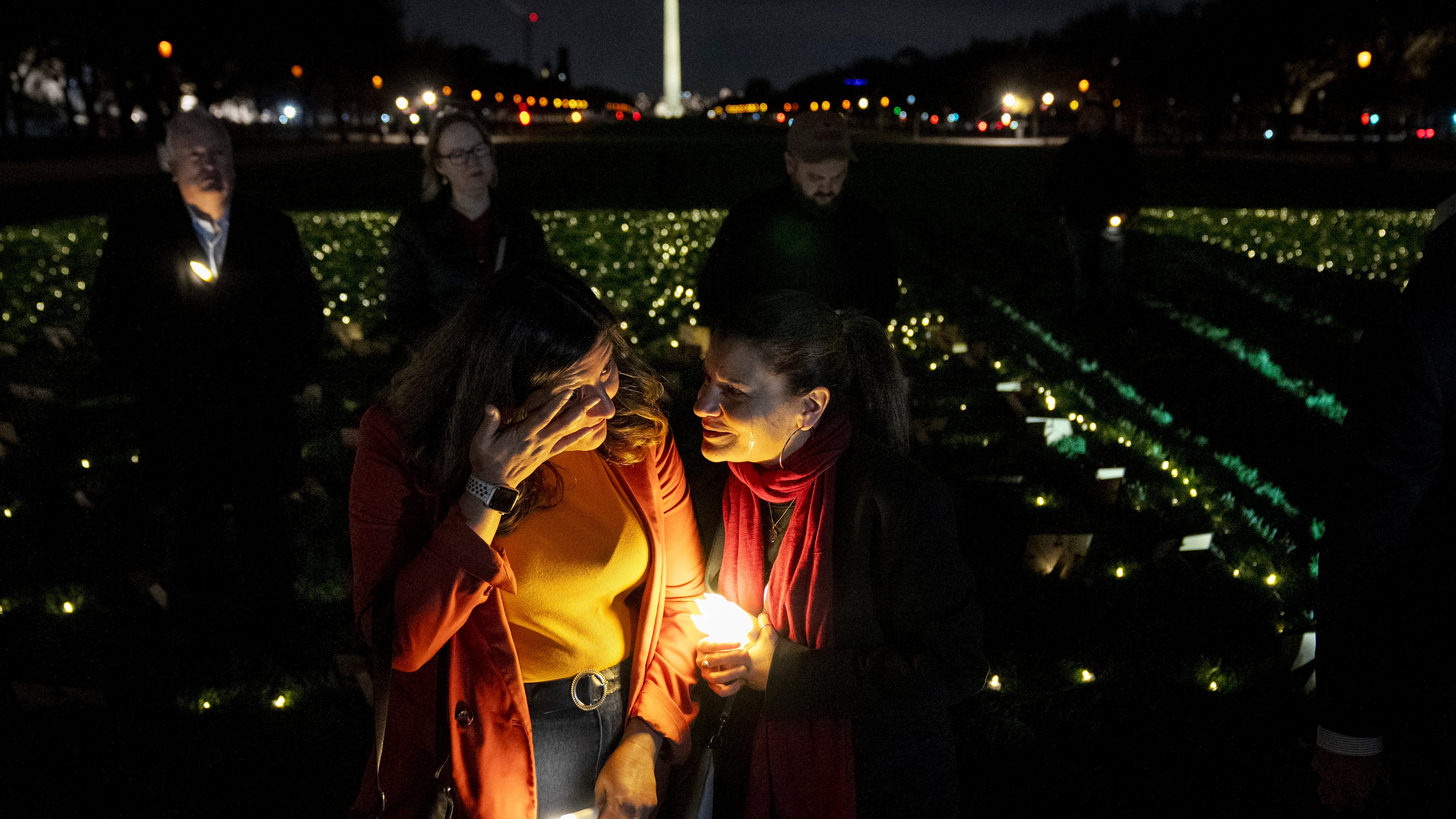 FILE - Madiha Maria, left, cries with Rana Abbas Taylor of Northville, Mich., who lost her only sister, brother-in-law and their three children to a drunk driver, during a candlelight vigil for people who had family members killed by drunk drivers, Tuesday, Nov. 19, 2024, on the National Mall, in Washington. (AP Photo/Jacquelyn Martin, File)