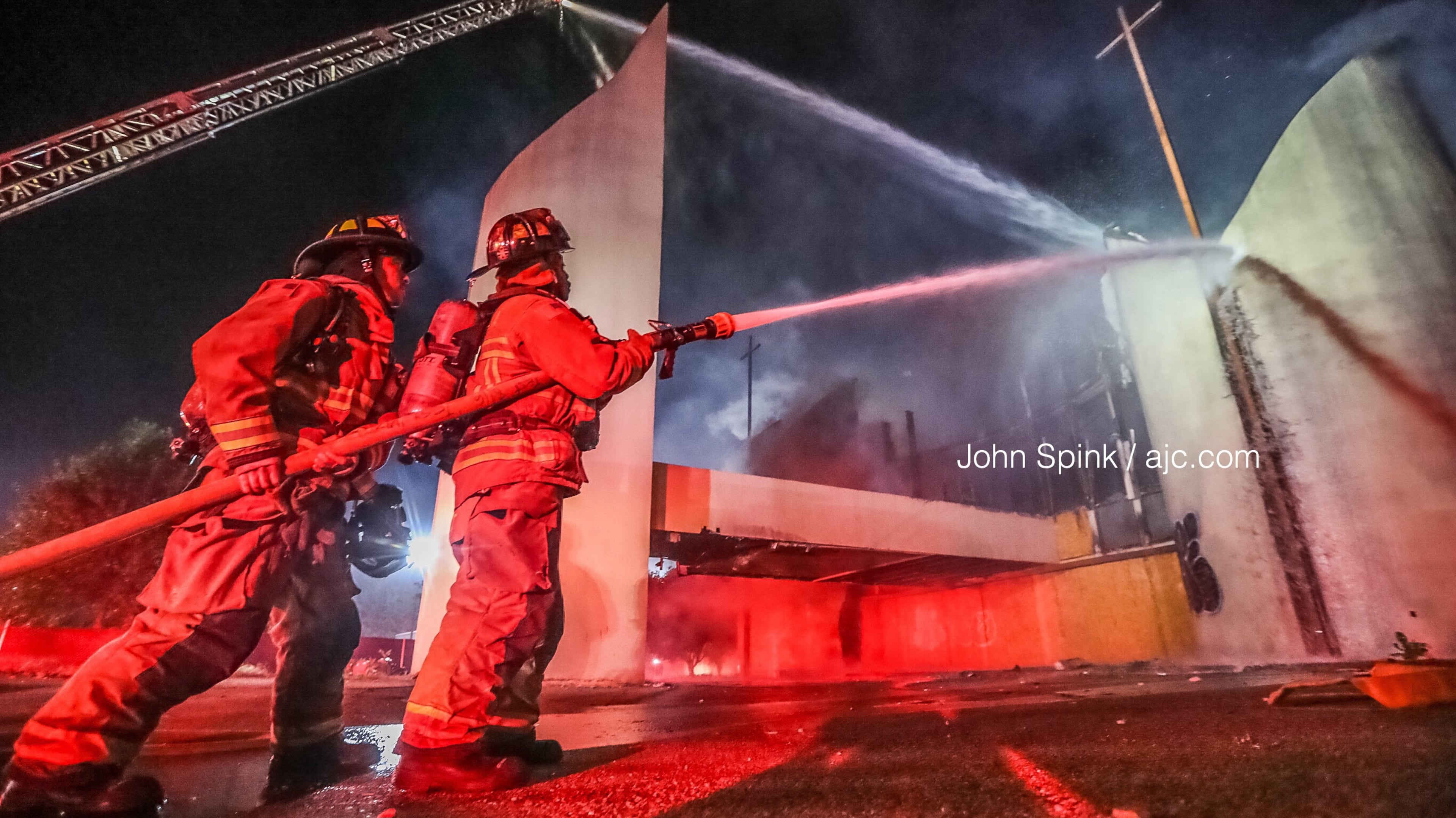 Alanta fire crews douse the blaze Friday morning at an abandoned church building on Clifton Street near Alonzo A. Crim Open Campus High School.