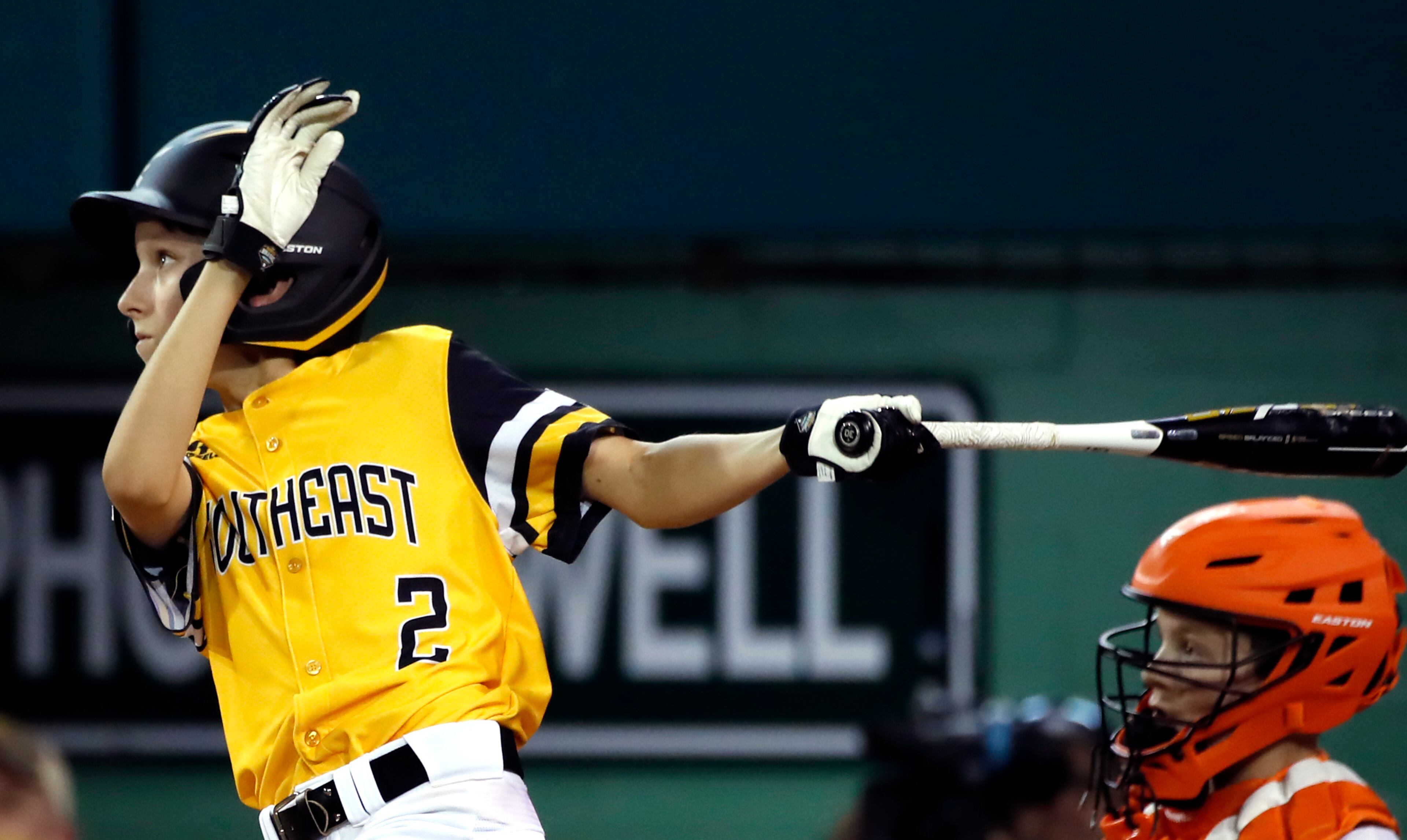 Peachtree City, Georgia's Ben Traxler (2) follows through hon his base hit scoring the winning run against Houston, Texas of an elimination baseball game at the Little League World Series tournament in South Williamsport, Pa., Monday, Aug. 20, 2018. Peachtree City, Georgia won the game 7-6 in 9 innings, eliminating Houston, Texas. (AP Photo/Tom E. Puskar)