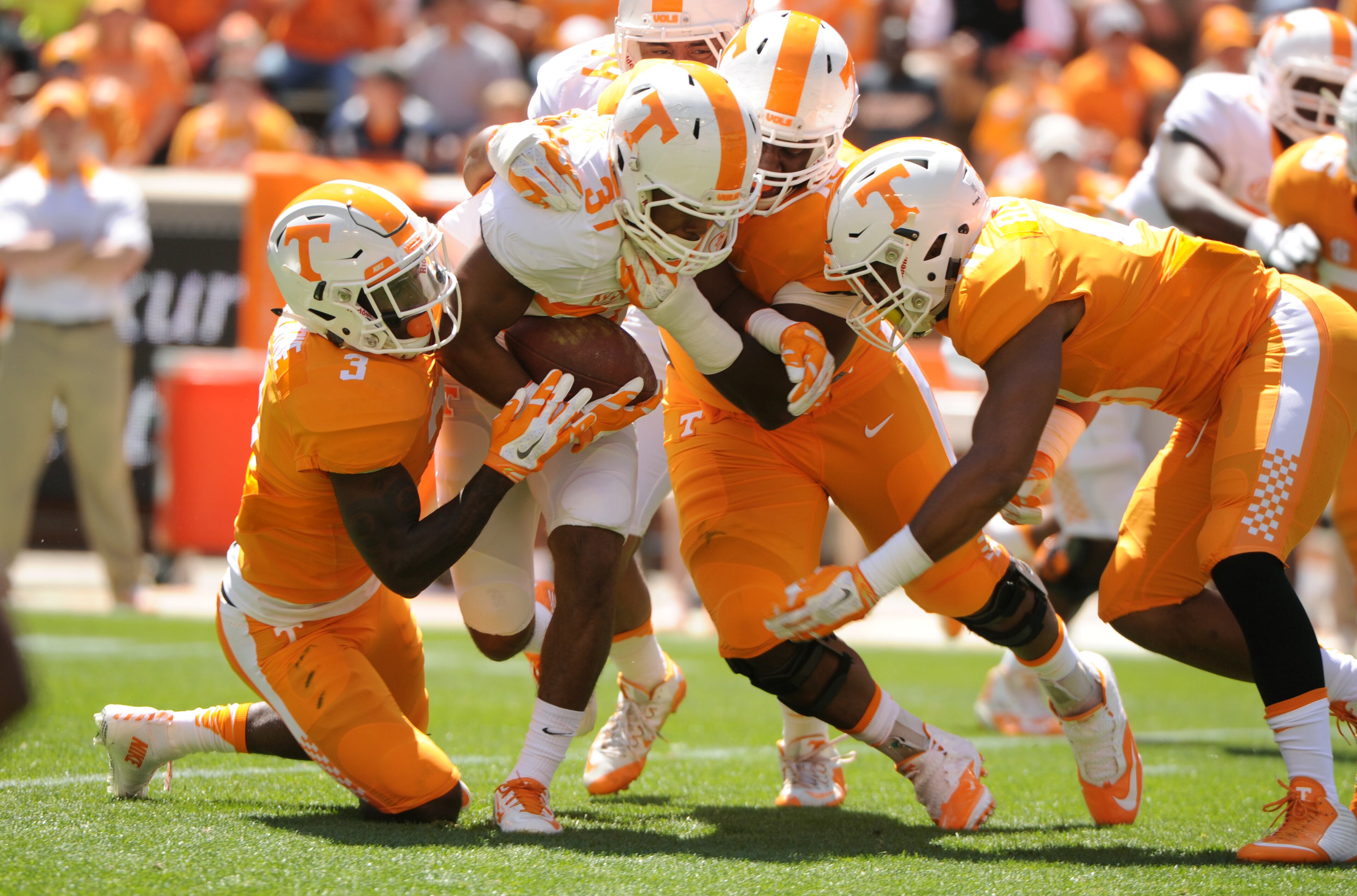 Tennessee's Jayson Sparks is tackled by several defensive players during an NCAA college football spring game in Knoxville, Tenn., Saturday, April 16, 2016. (Michael Patrick/Knoxville News Sentinel via AP)