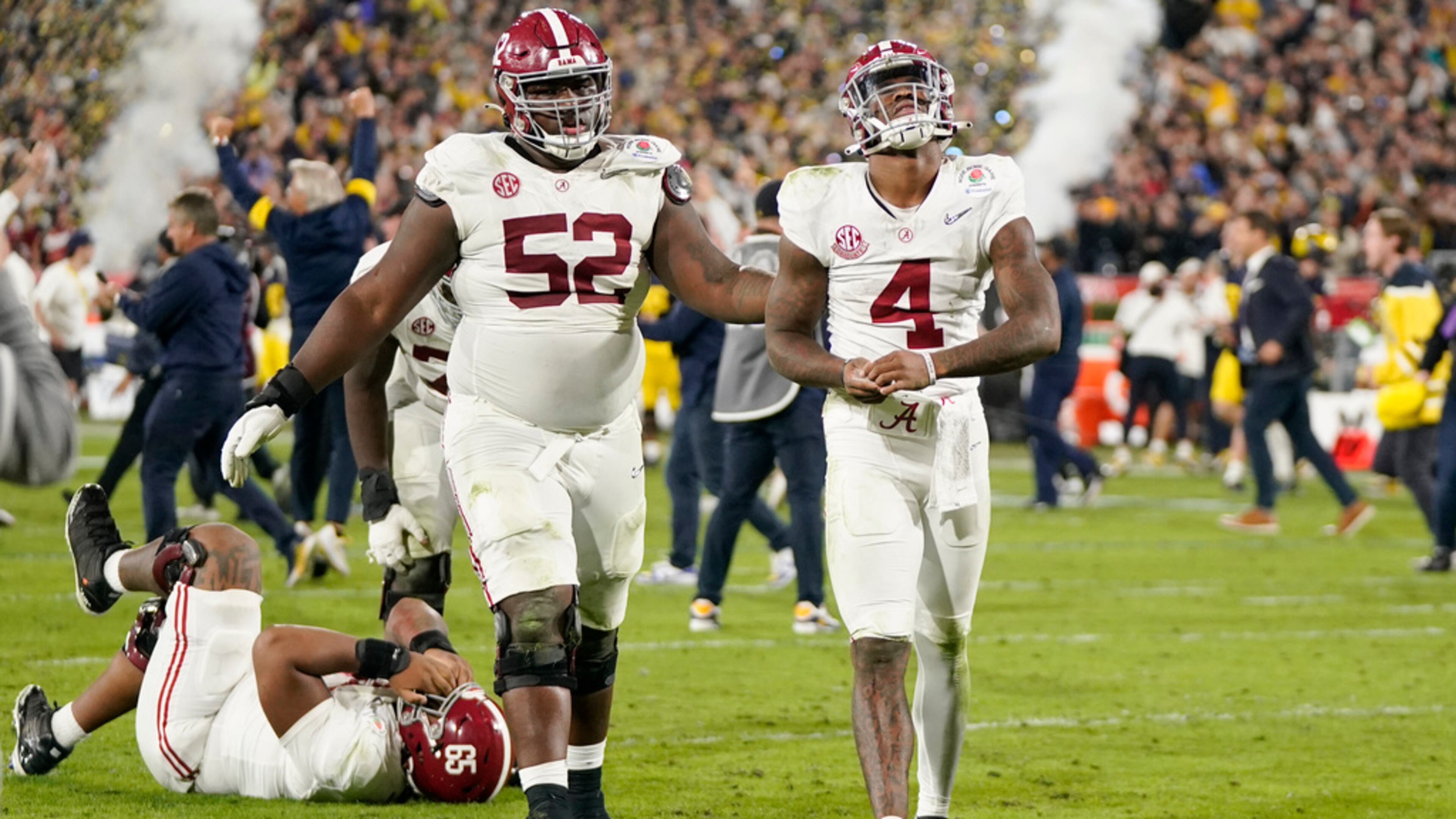 Alabama quarterback Jalen Milroe (4) and offensive lineman Tyler Booker (52) walk off the field after a loss to Michigan in the Rose Bowl CFP NCAA semifinal college football game Monday, Jan. 1, 2024, in Pasadena, Calif. (AP Photo/Mark J. Terrill)