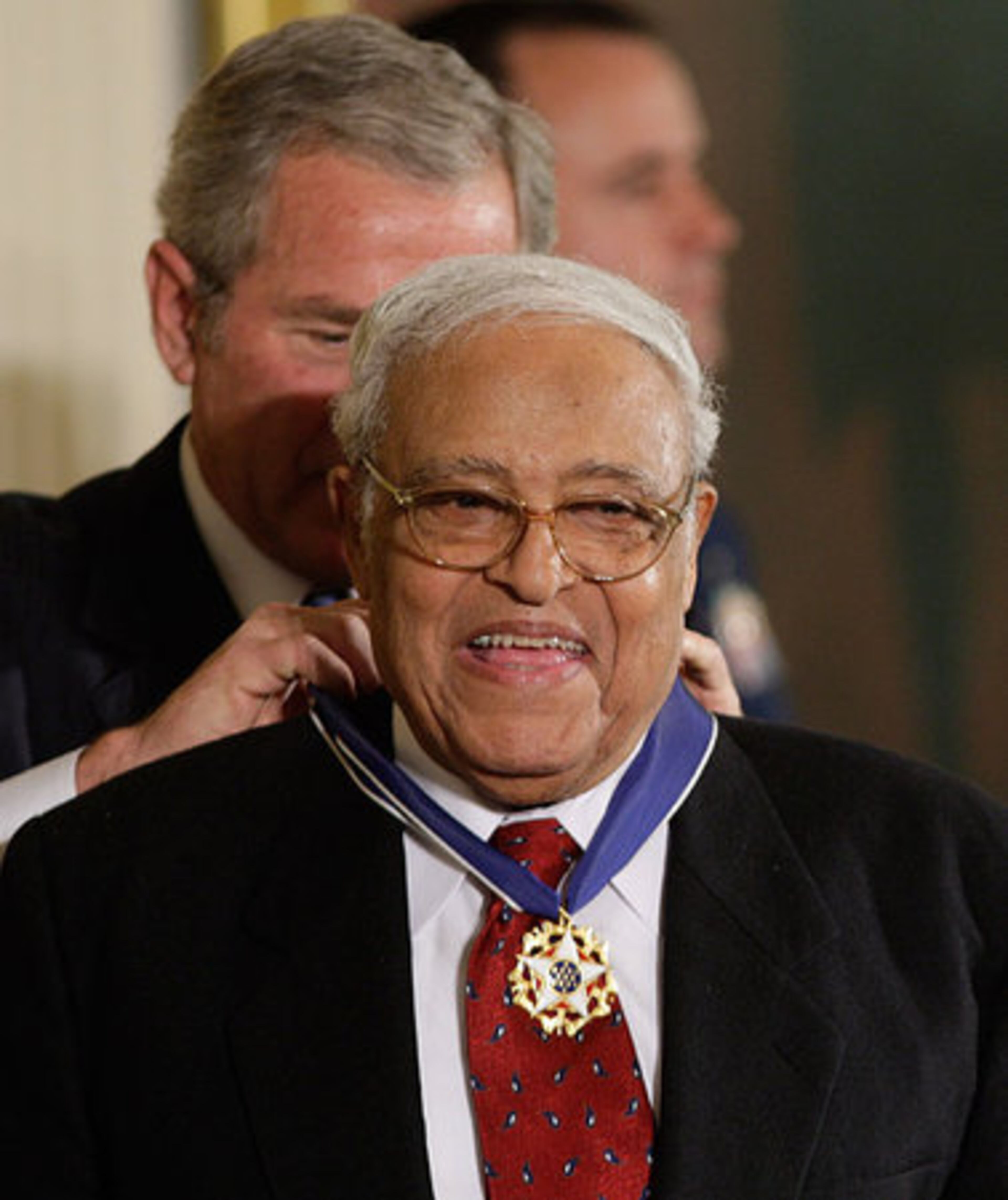 In this Nov. 5, 2007 file photo, President Bush, left, presents the Presidential Medal of Freedom to Civil Rights pioneer Benjamin Hooks, during a ceremony in the East Room of the White House in Washington. Hooks, a champion of minorities and the poor whose longtime tenure as executive director of the NAACP included leading his organization through a deadly firebombing campaign that targeted his group, died early Thursday said State Rep. Ulysses Jones. He was 85.