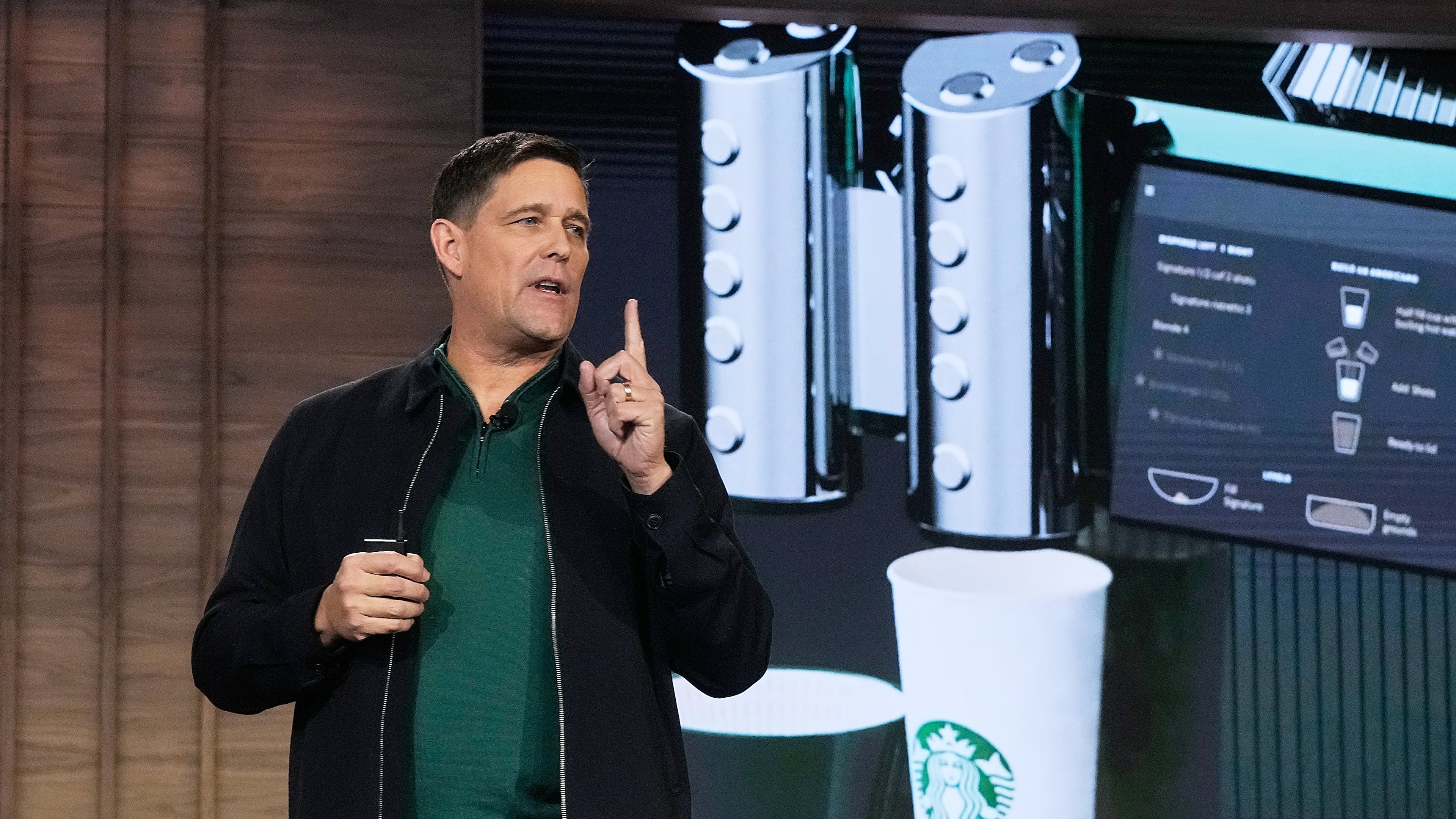 Executive Vice President and Chief Operating Officer Mike Grams speaks during the Starbucks Investor Day event, with an image of the company's Mastrena 3 espresso machine, in New York, Thursday, Jan. 29, 2026. (AP Photo/Richard Drew)