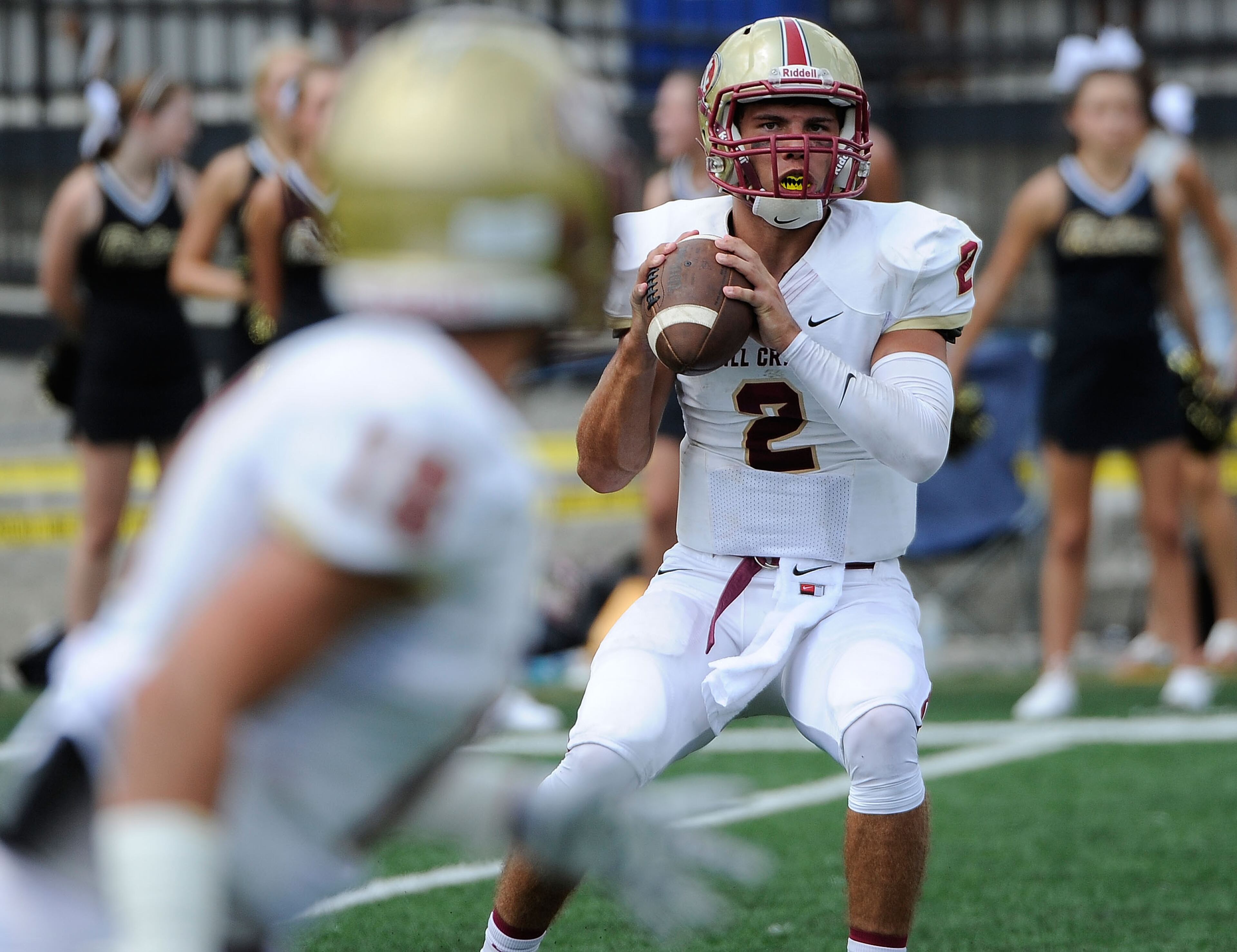 Mill Creek quarterback Daniel David (2) looks for an open player against Colquitt in the first half of their Corky Kell Classic football game Saturday, Aug. 23, 2014, in Powder Springs, Ga. David Tulis / AJC Special