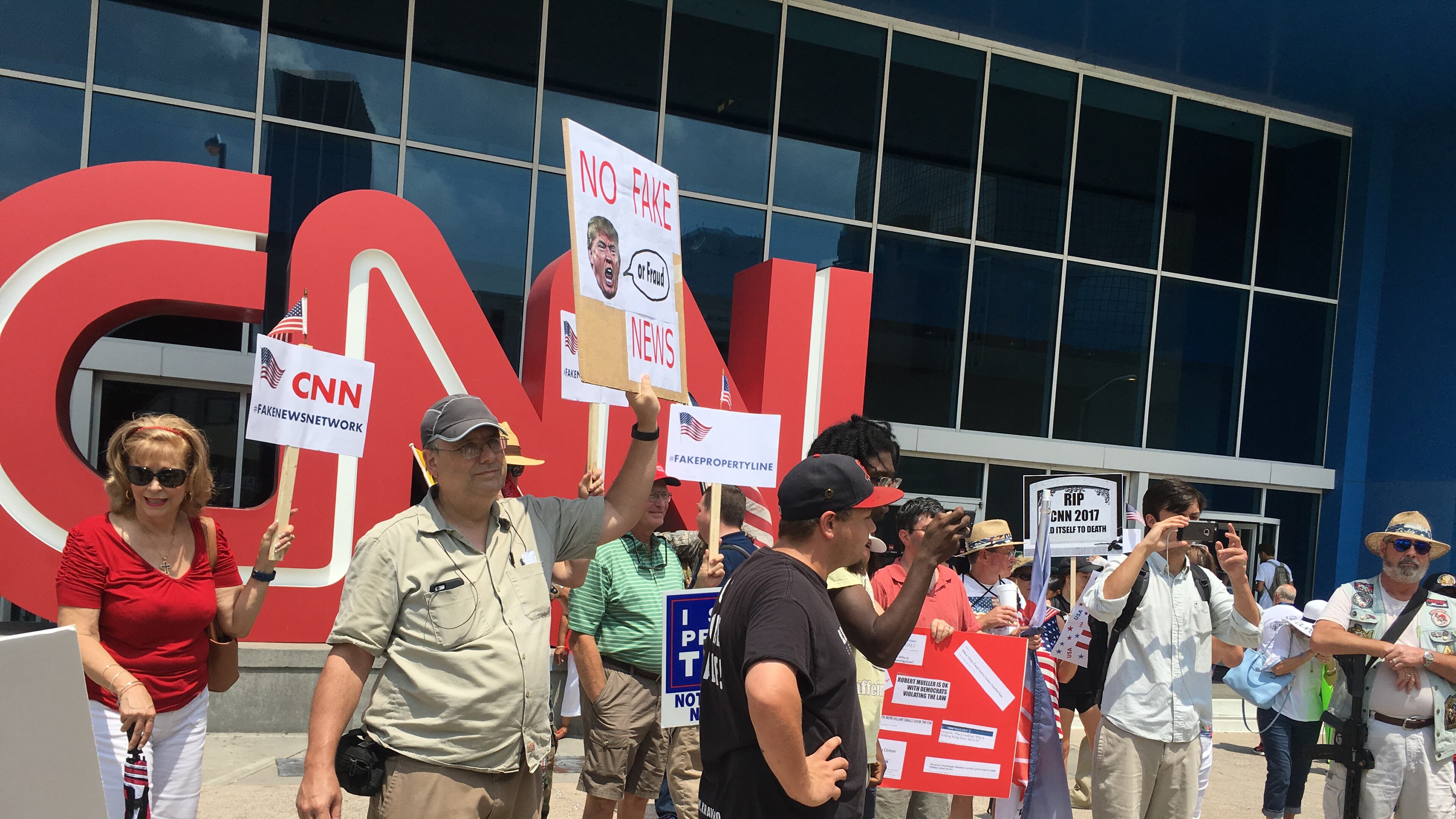 People demonstrated against CNN news coverage Saturday in Atlanta. RHONDA COOK / RHONDA.COOK@AJC.COM