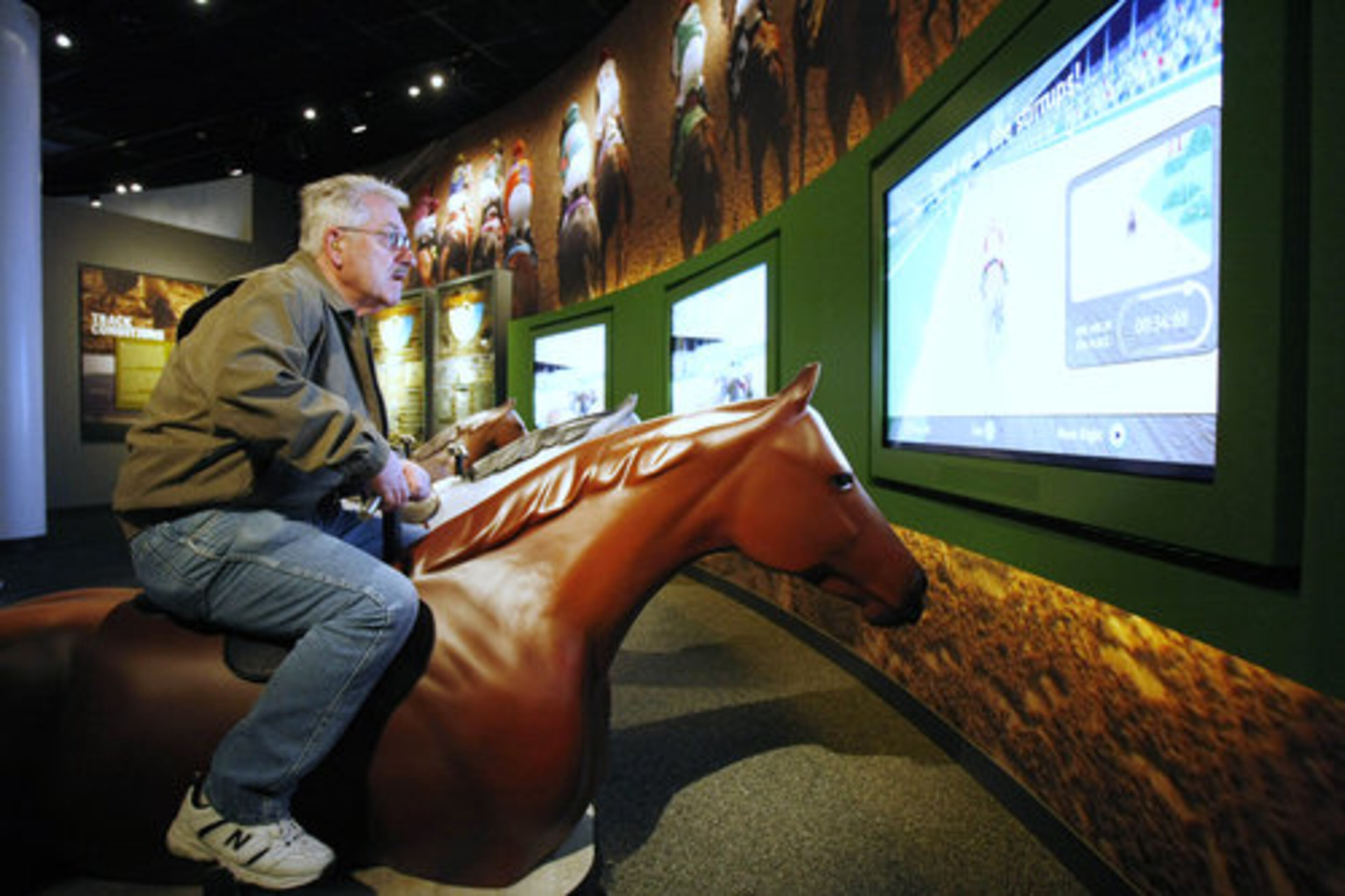 Bill Warner of Locke, N.Y., rides a race simulator during a visit to the Kentucky Derby Museum in Louisville, Ky.