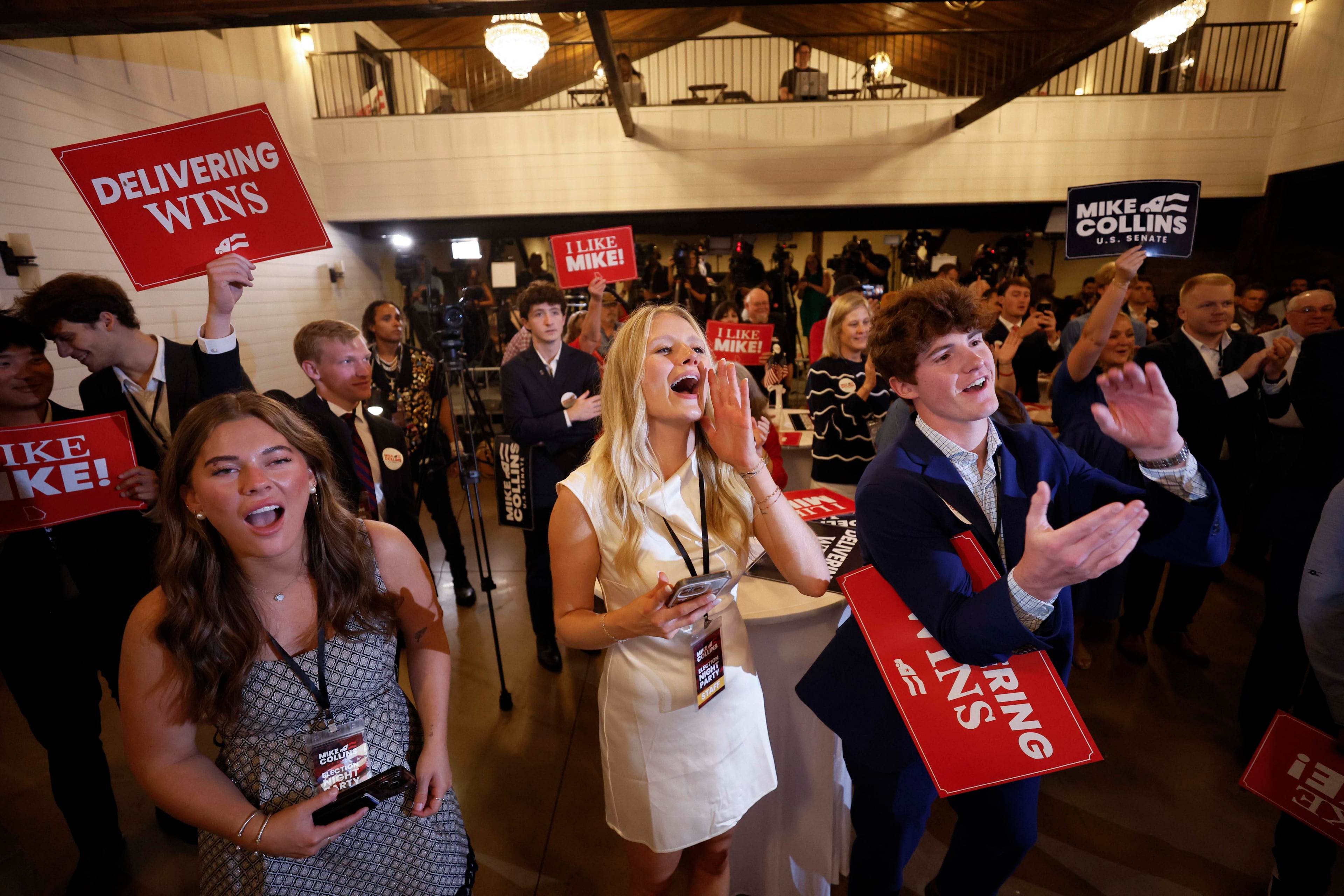 Supporters of U.S. Rep. Mike Collins cheer as they watch him speak onstage during the runoff election watch party at Seven Oaks Manor in Jackson, Georgia, on Tuesday, June 16, 2026. (Miguel Martinez/AJC)