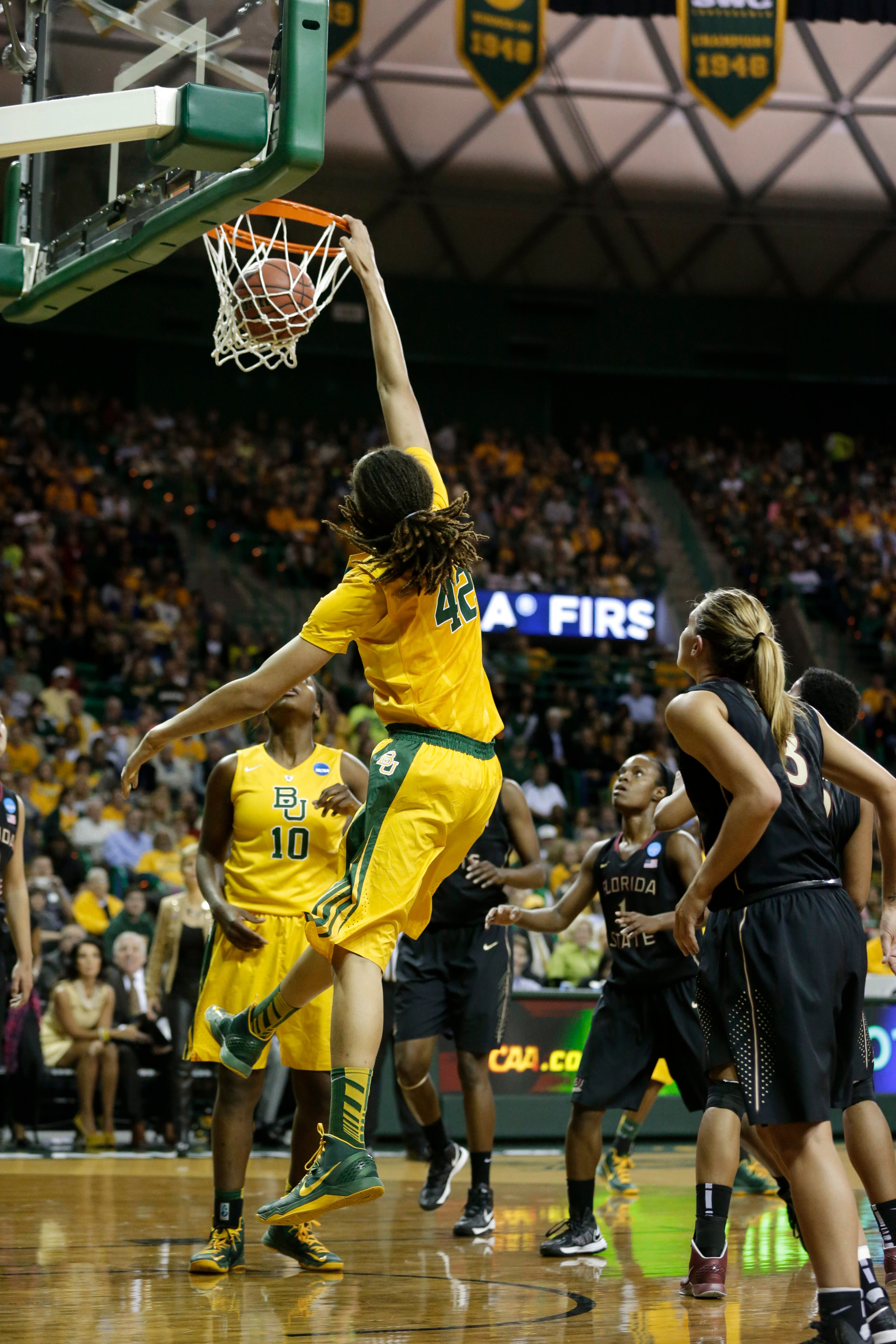 Baylor's Brittney Griner (42) dunks as the Florida State's Alexa Deluzio (3) and the rest of the field watch in the second half of a second-round game in the women's NCAA college basketball tournament Tuesday, March 26, 2013, in Waco, Texas. Griner dunked three times in the 85-47 Baylor win. (AP Photo/Tony Gutierrez)
