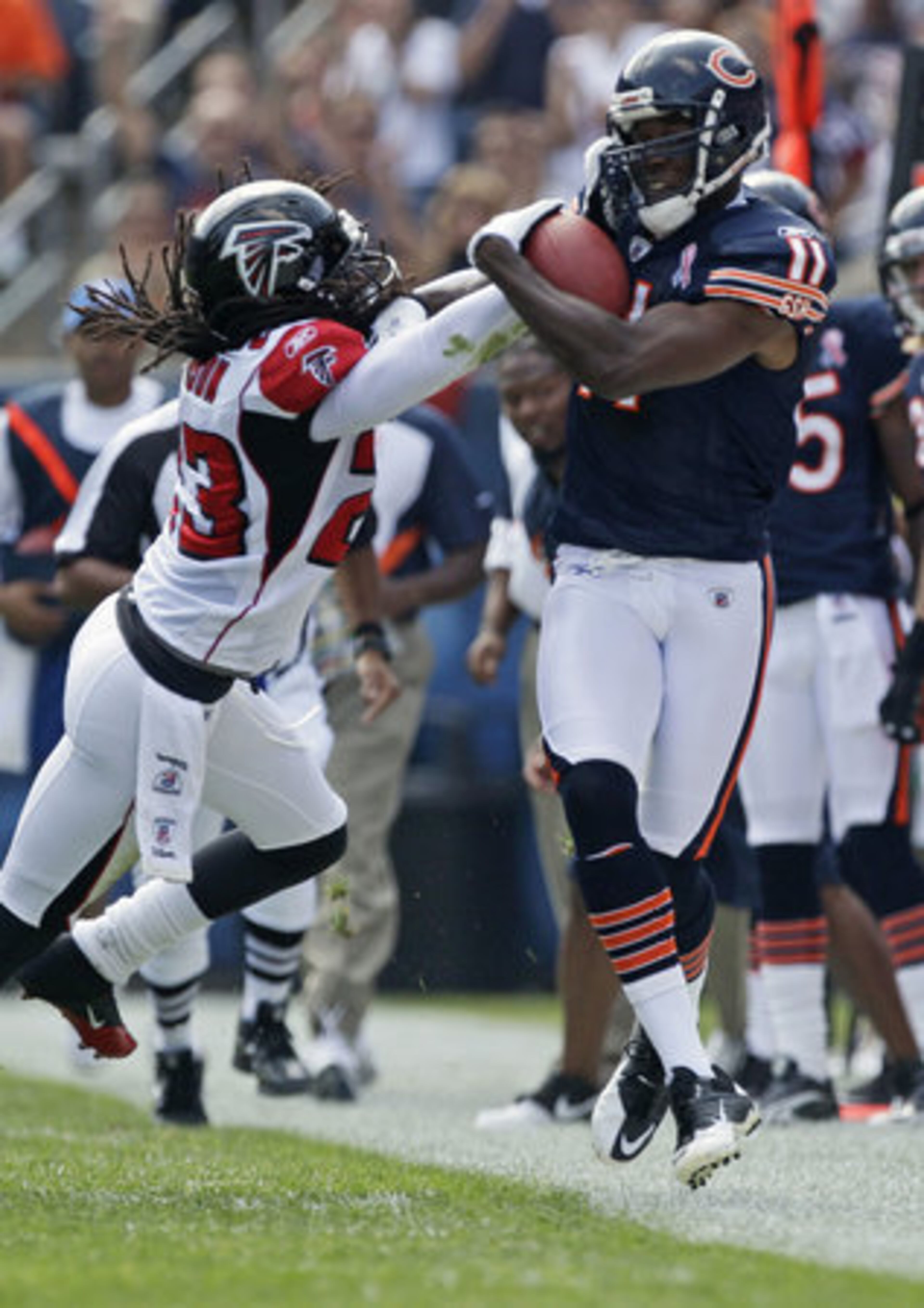 Chicago Bears wide receiver Roy Williams (11) makes a reception while covered by Atlanta Falcons cornerback Dunta Robinson (23) in the first half.