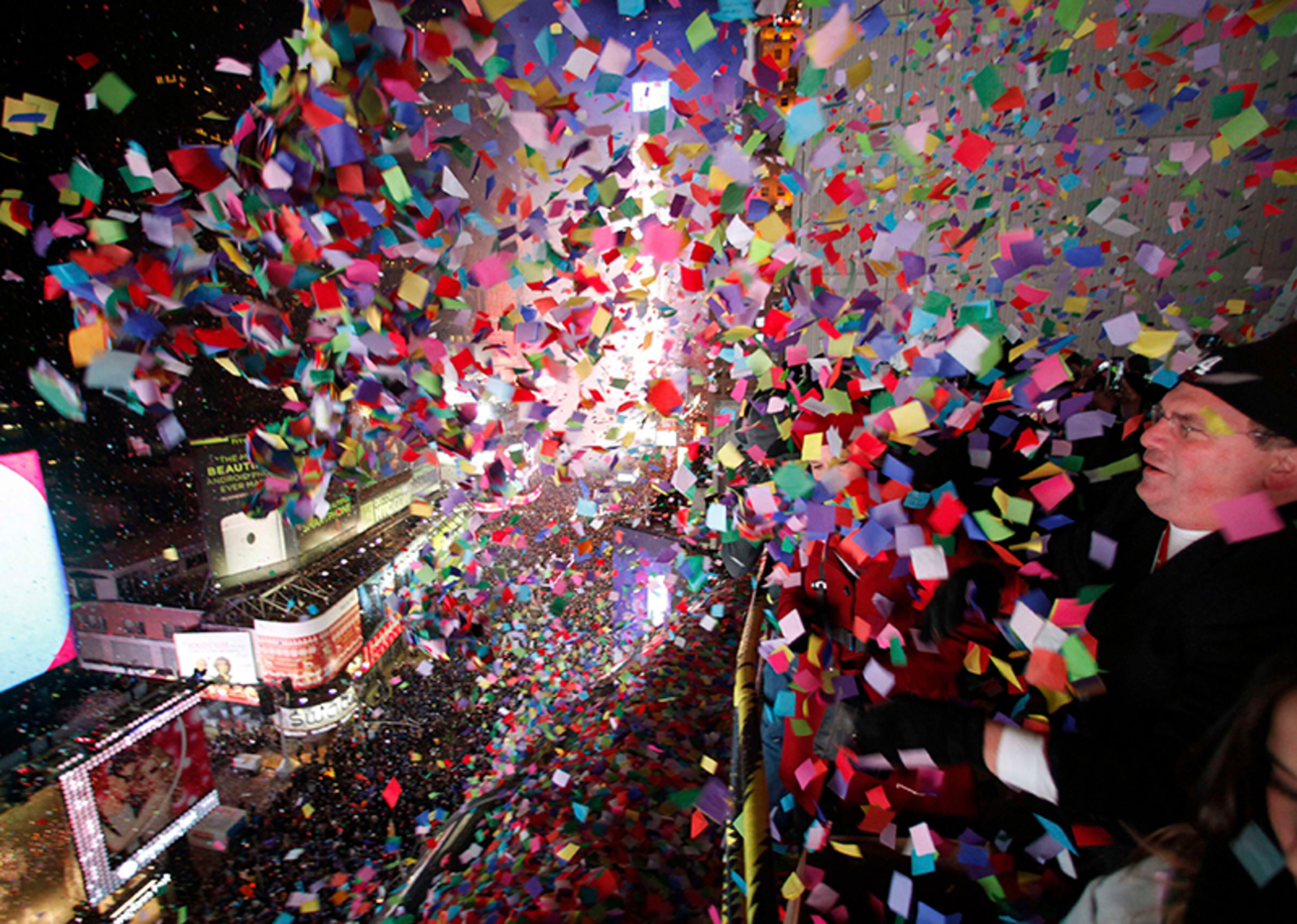 Confetti - with handwritten resolutions - is dropped on revelers at midnight during New Year's Eve celebrations Jan. 1, 2014, in Times Square in New York.
