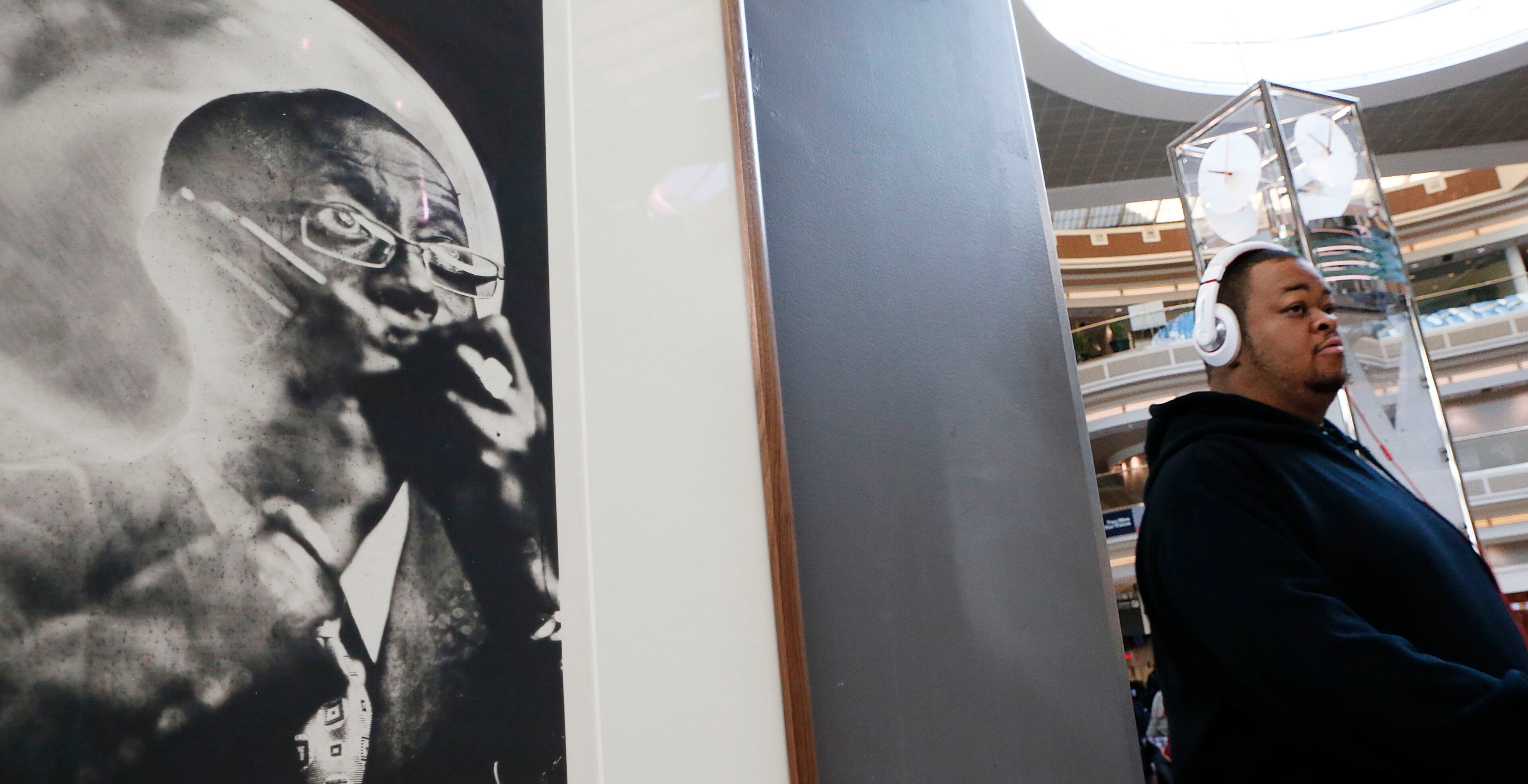 Southwest driver Cory Smith walks past a photograph titled "Dr. Dixon, Bluesman, Atlanta, GA. 2014". A Music Makers Relief Foundation art exhibit debuted in the airport atrium Friday with platinum palladium prints of blues musicians. For 35 years photographer Tim Duffy has photographed Southern musicians and the world in which they live using wet-plate collodion photography. Record crowds are expected along with long lines and delays at Hartsfield-Jackson Atlanta International Airport, the world's busiest airport, which is forecasting some of the biggest increases in traffic it has seen in years. BOB ANDRES / BANDRES@AJC.COM
