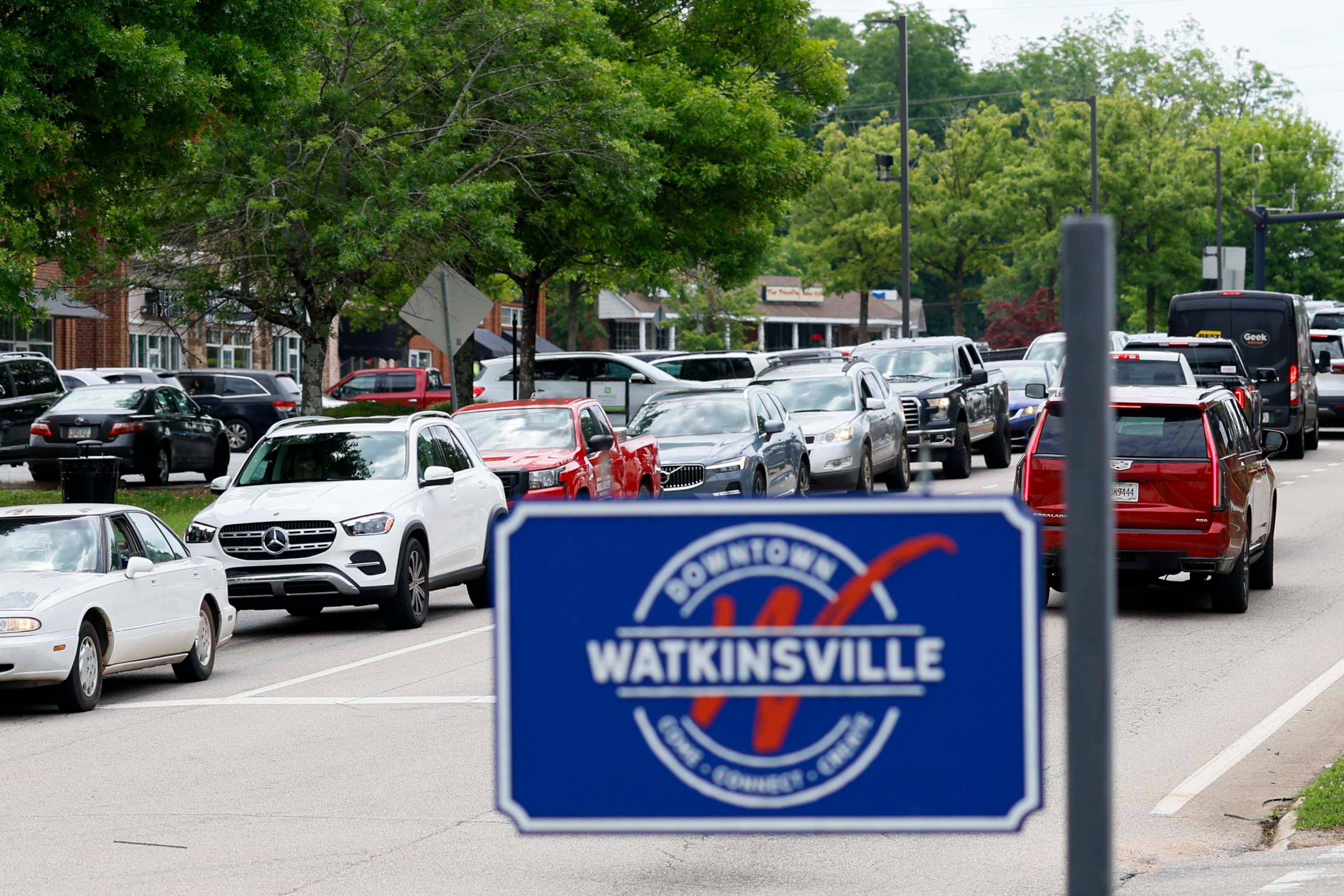 Bumper-to-bumper traffic is observed in both directions on Main Street in downtown Watkinsville around lunchtime on Thursday, May 29, 2026. A proposed highway bypass is aimed at easing traffic, but affected rural landowners are pushing back. (Miguel Martinez/AJC)