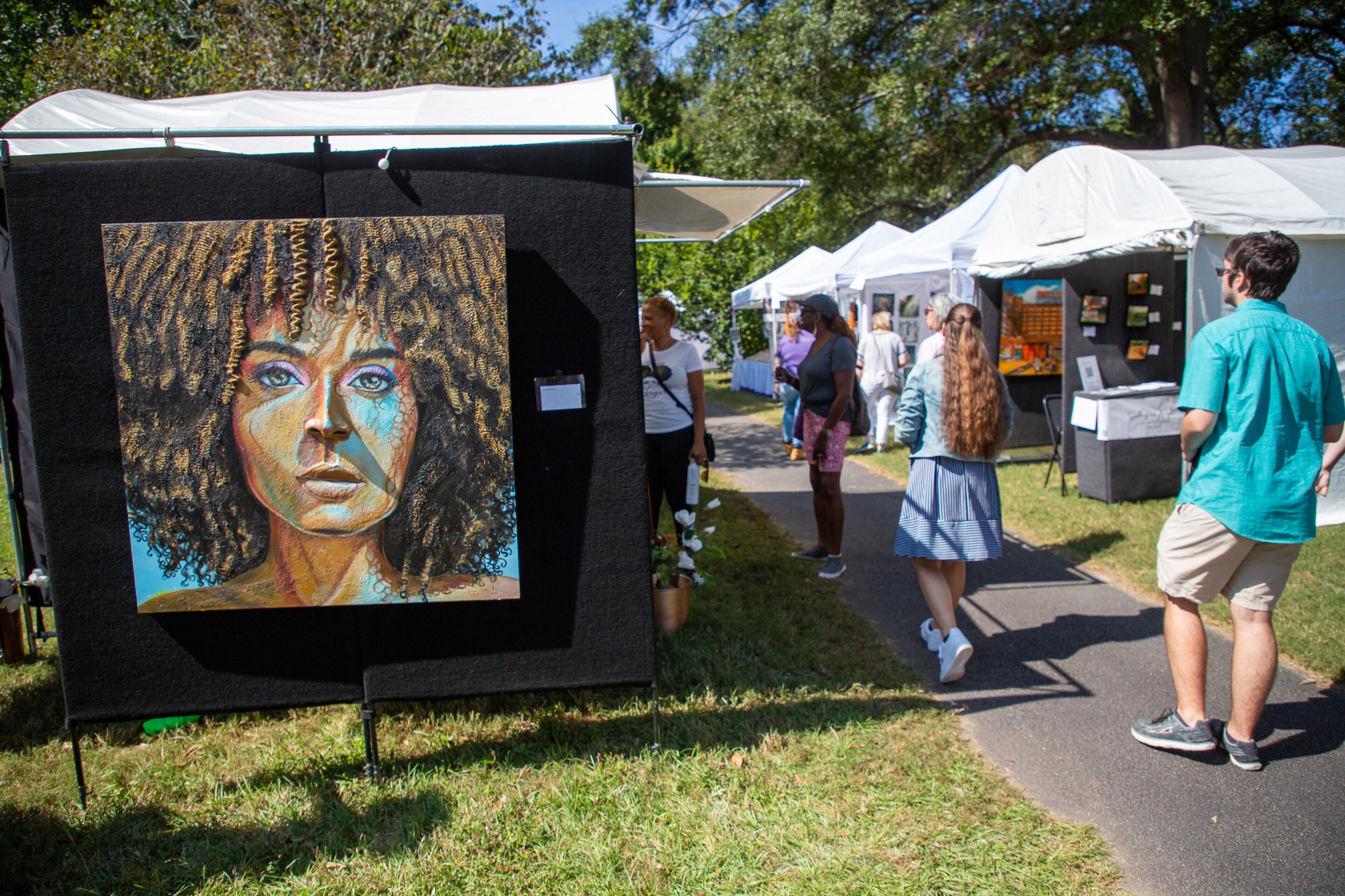 People walk by the artists' booths during the Festival on Ponce on Sunday, October 10, 2021. Presented by the Atlanta Foundation for Public Spaces, the fest in Olmsted Linear Park featured more than 125 displays of arts and crafts. (Photo: Steve Schaefer for The Atlanta Journal-Constitution)