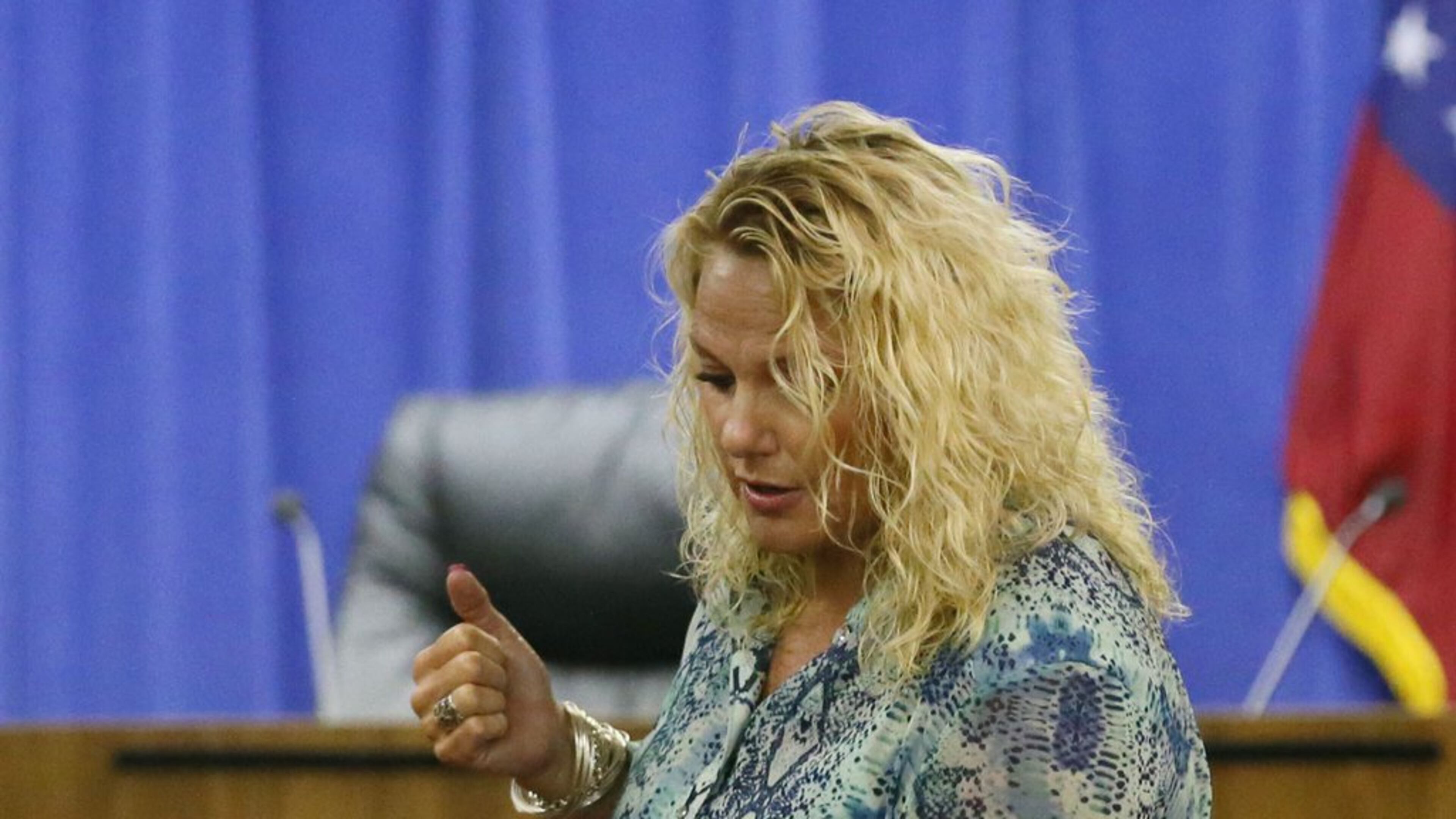 Mary Katherine Pursley demonstrates for a school system hearing how she says she held a student over a trash can. The veteran Cobb County special education teacher is accused of putting a second-grader with autism in a trash can and calling him Oscar the Grouch. “My intention was not to put him all the way in the can,” Pursley told a panel of former educators at the hearing, who will decide if she’s fired. “I was sort of shaking him over the trash can.” BOB ANDRES / BANDRES@AJC.COM