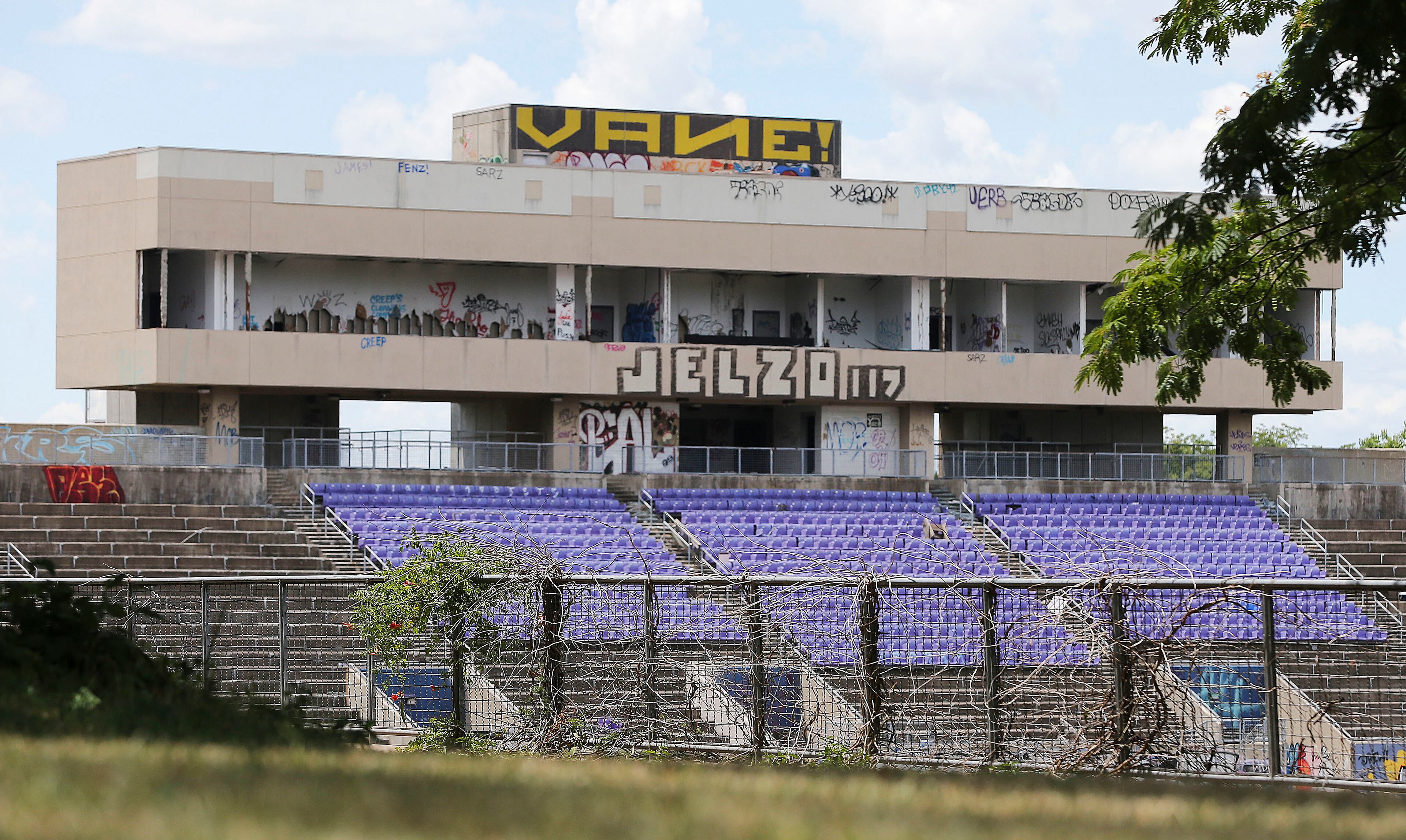In this July 18, 2016 photo, Herndon Stadium, home of the 1996 Summer Olympic Games field hockey events sits vacant in Atlanta. Perhaps the saddest legacy of the games, this 15,000-seat stadium was used during the filming of the movie "We Are Marshall" but was abandoned after Morris Brown College ran into financial difficulties. Gutted by vandals, it is now covered in graffiti and piles of trash. (AP Photo/John Bazemore)
