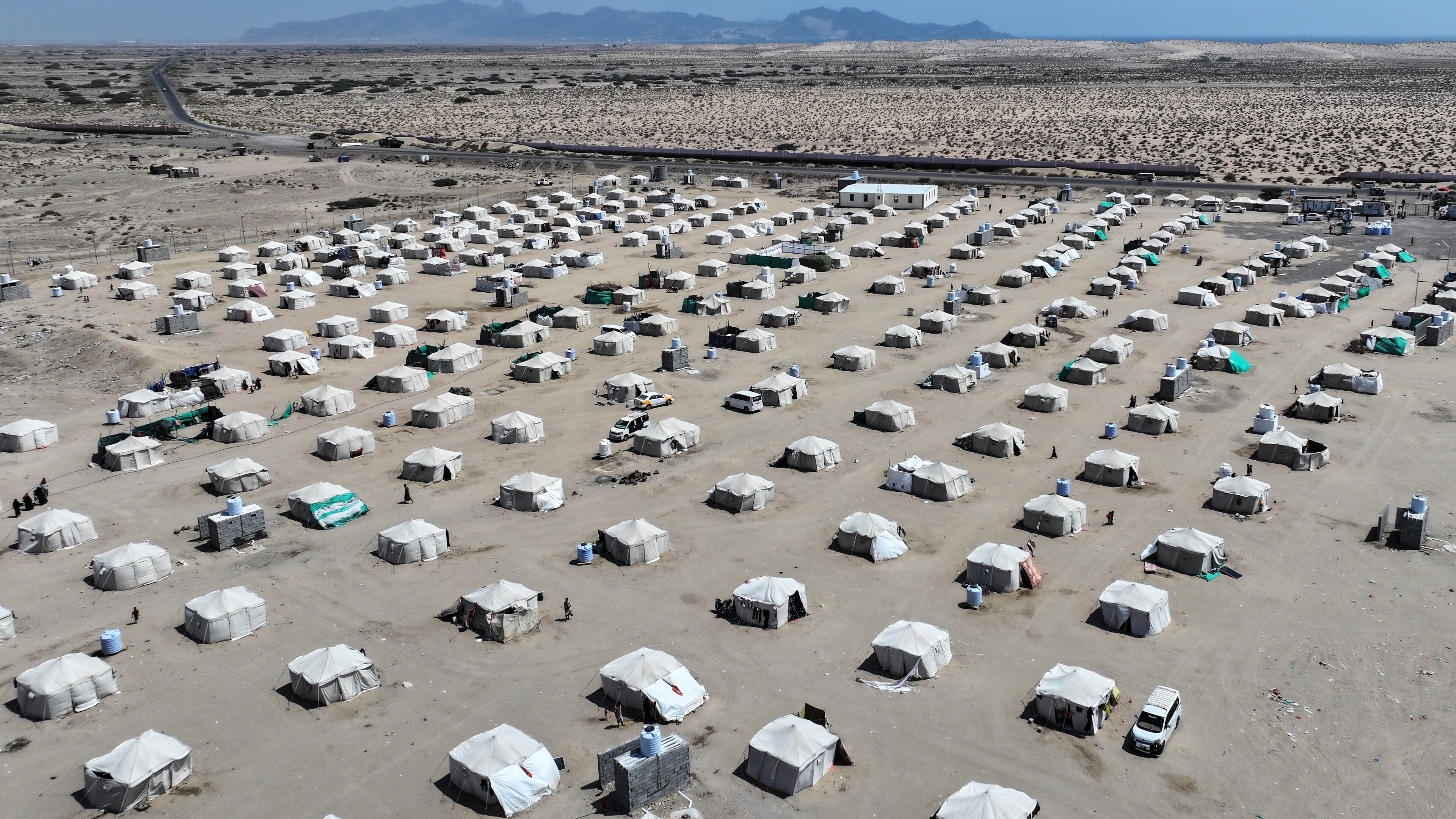 An aerial view shows rows of tents sheltering displaced Yemenis at the Al-Fardous displacement camp in Ras Imran, on the outskirts of Aden, Yemen, Sunday, Oct. 25, 2026. (AP Photo/Abdulnasser Alseddik)
