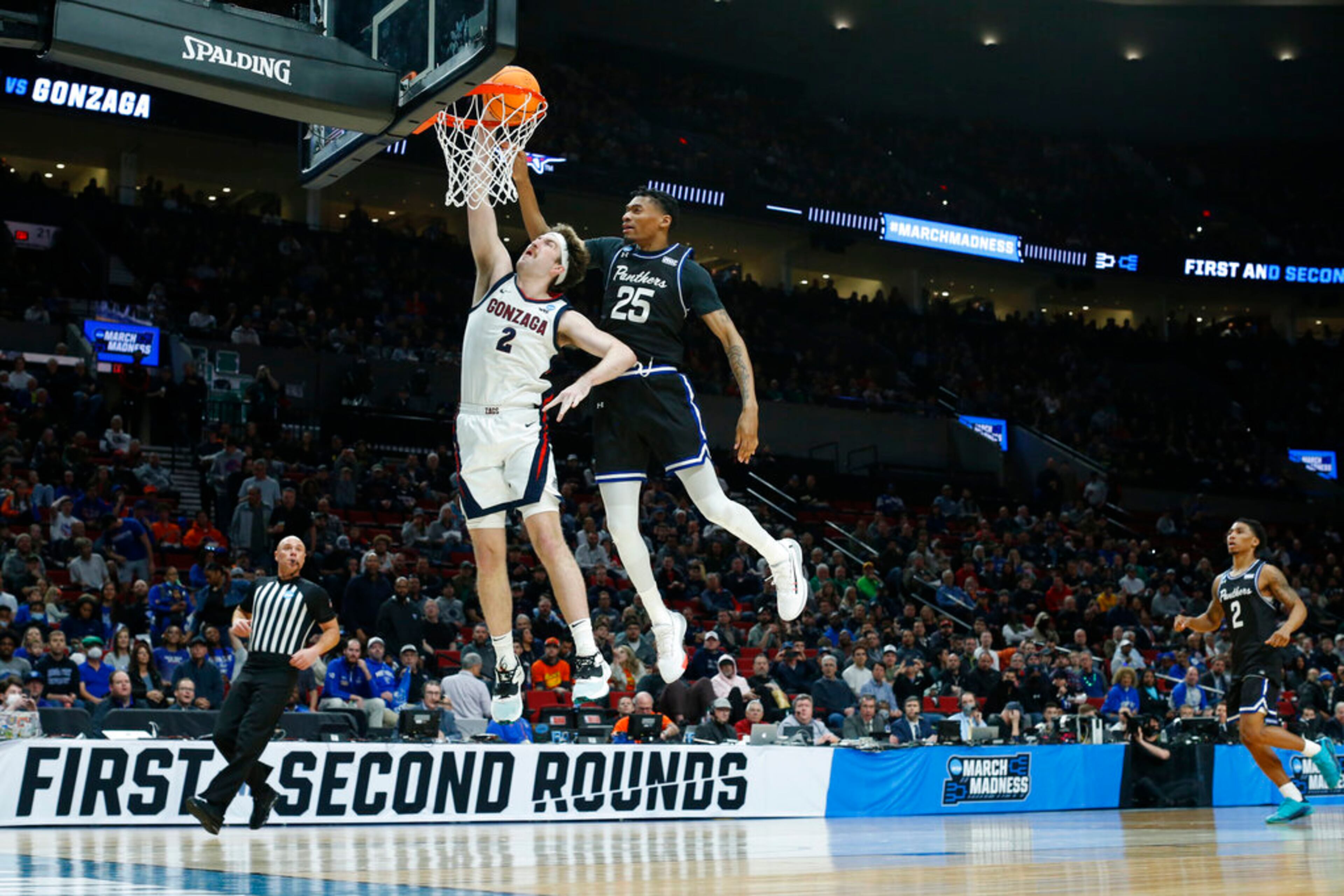 Gonzaga forward Drew Timme (2) dunks in front of Georgia State forward Jalen Thomas (25) during the first half of a first round NCAA college basketball tournament game, Thursday, March 17, 2022, in Portland, Ore. (AP Photo/Craig Mitchelldyer)