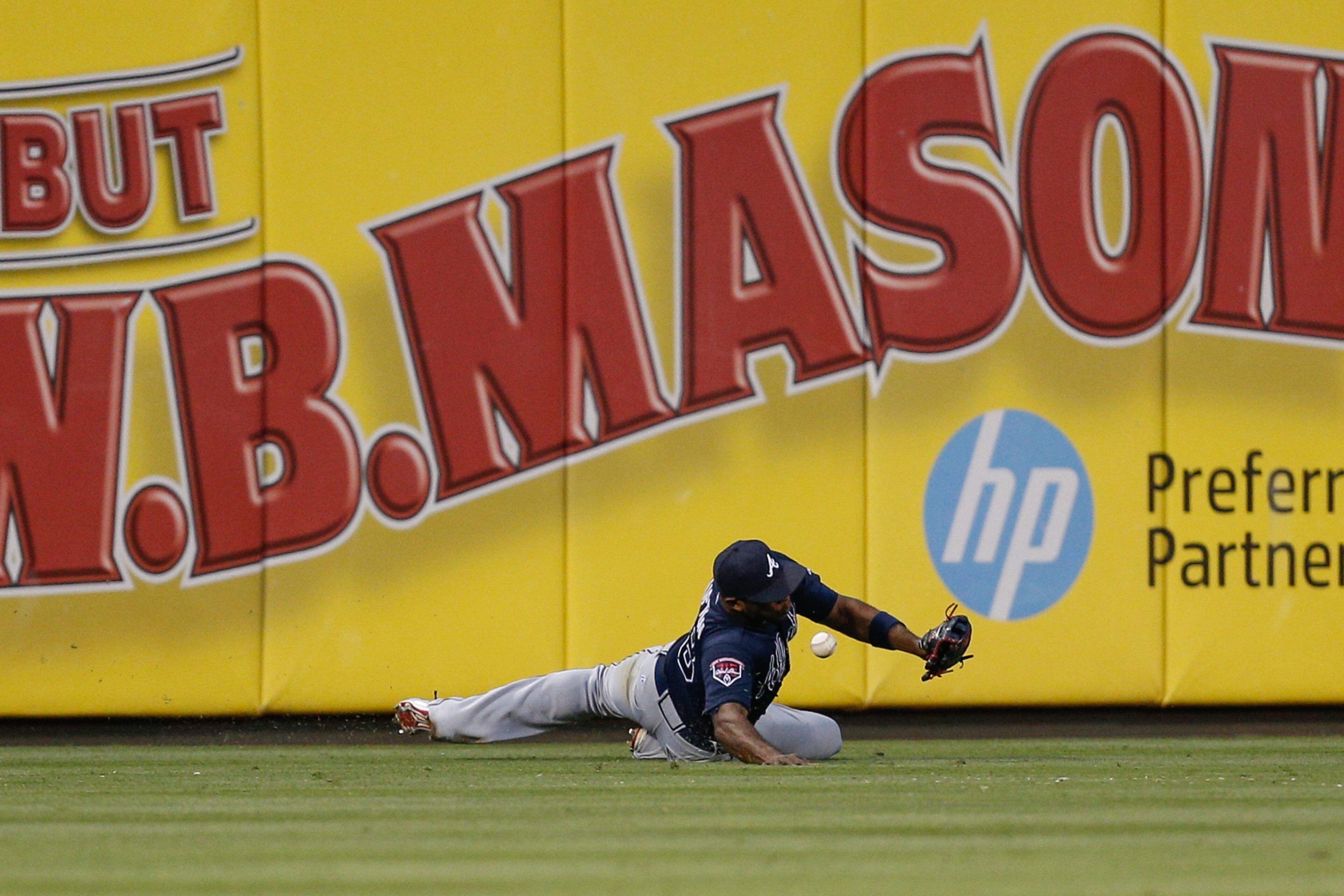 PHILADELPHIA, PA - JUNE 27: Justin Upton #8 of the Atlanta Braves misses catching a Marlon Byrd #3 of the Philadelphia Phillies hit in the fourth inning of the game at Citizens Bank Park on June 27, 2014 in Philadelphia, Pennsylvania. Chase Utley #26 of the Philadelphia Phillies scored on the play. (Photo by Brian Garfinkel/Getty Images)