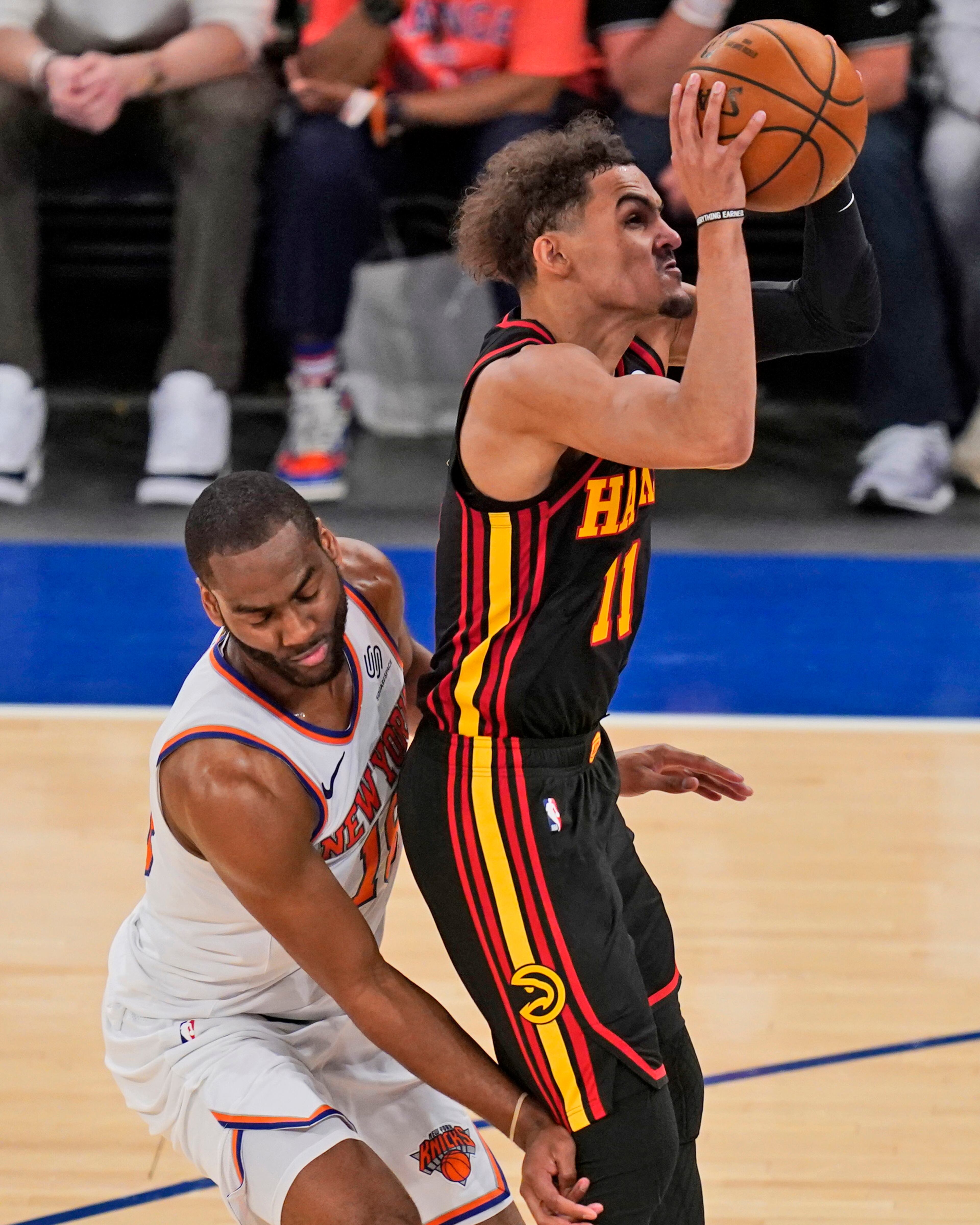 New York Knicks' Alec Burks (left) fouls Atlanta Hawks' Trae Young during the second half of Game 1 of first-round playoff series, Sunday, May 23, 2021, in New York. (Seth Wenig/AP)