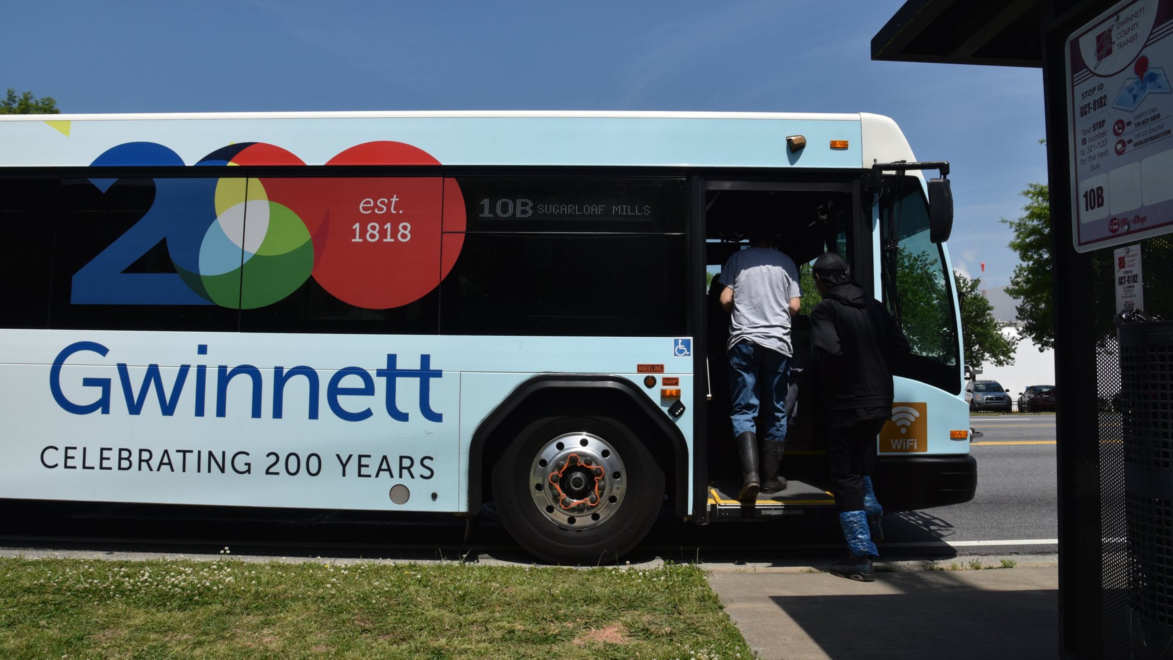 Customers get on a Gwinnett County Transit at Buford Highway and N. Berkeley Lake Road on Wednesday, May 2, 2018. HYOSUB SHIN / HSHIN@AJC.COM