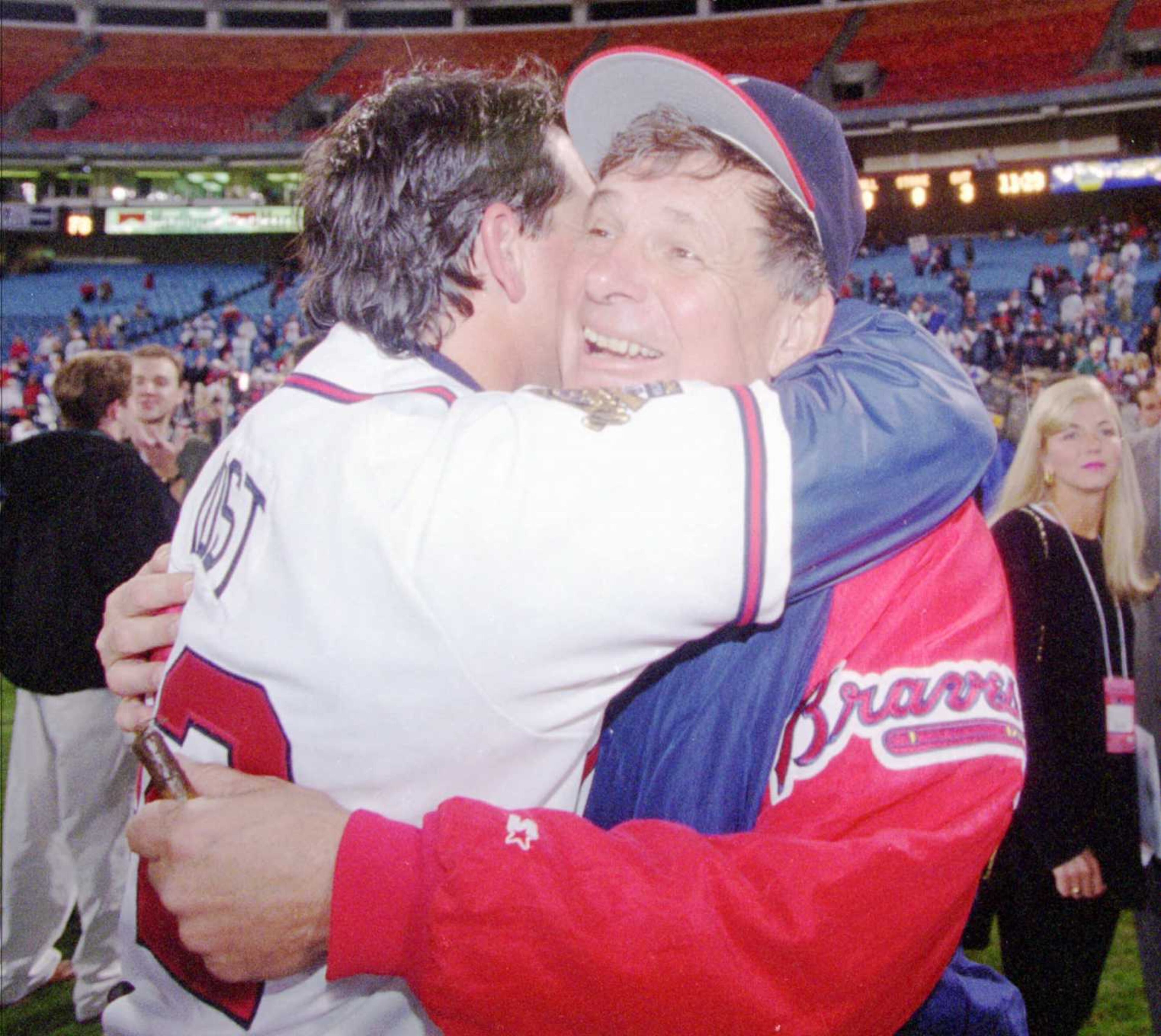 Braves manger Bobby Cox, right, hugs bullpen coach Ned Yost after the Braves' 1-0 victory over the Cleveland Indians in Game 6 of the World Series in Atlanta, Saturday, Oct. 28, 1995.