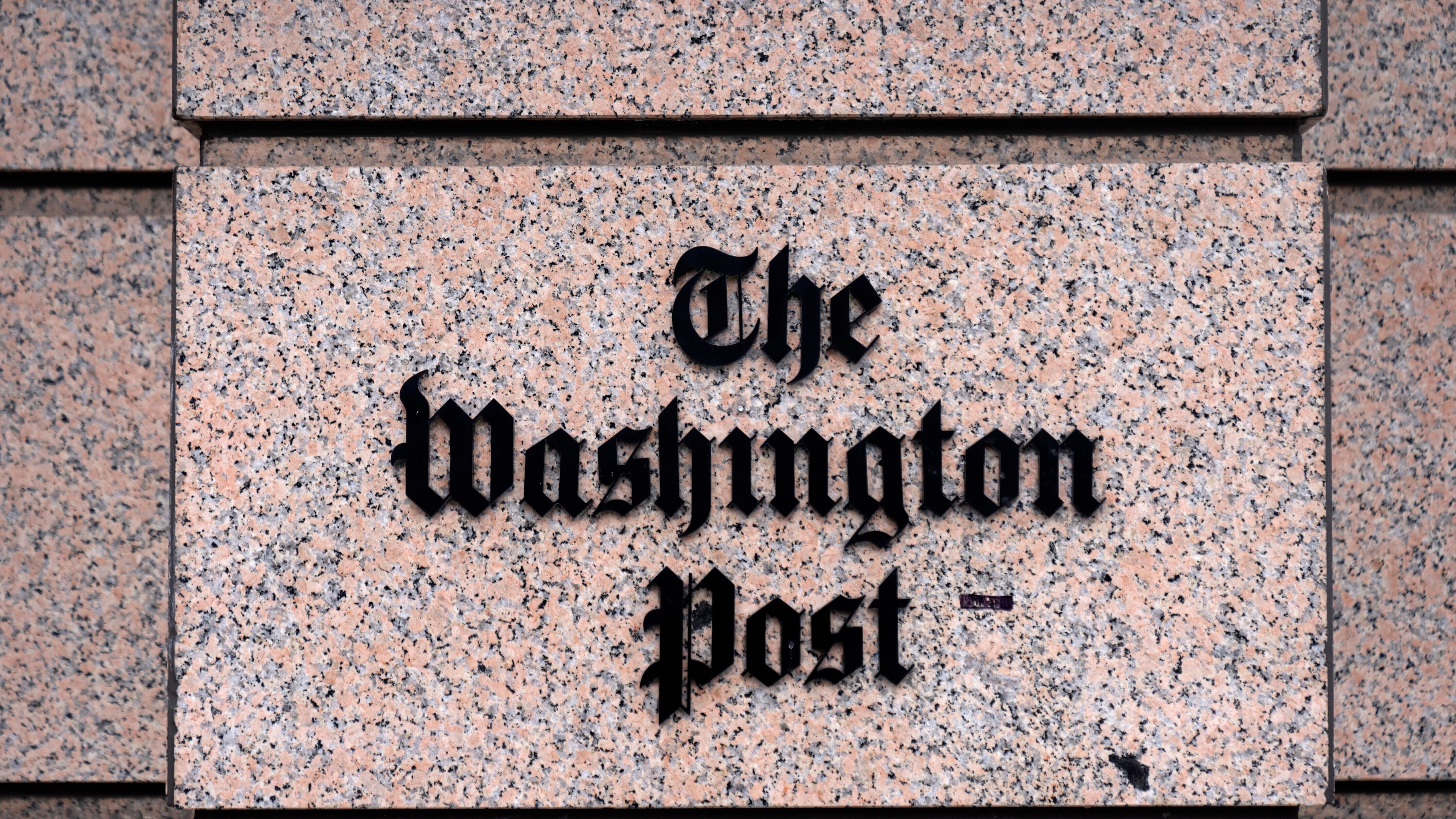 A sign for the Washington Post is seen at the company's offices, Monday, Jan. 26, 2026, in Washington. (AP Photo/Mark Schiefelbein)