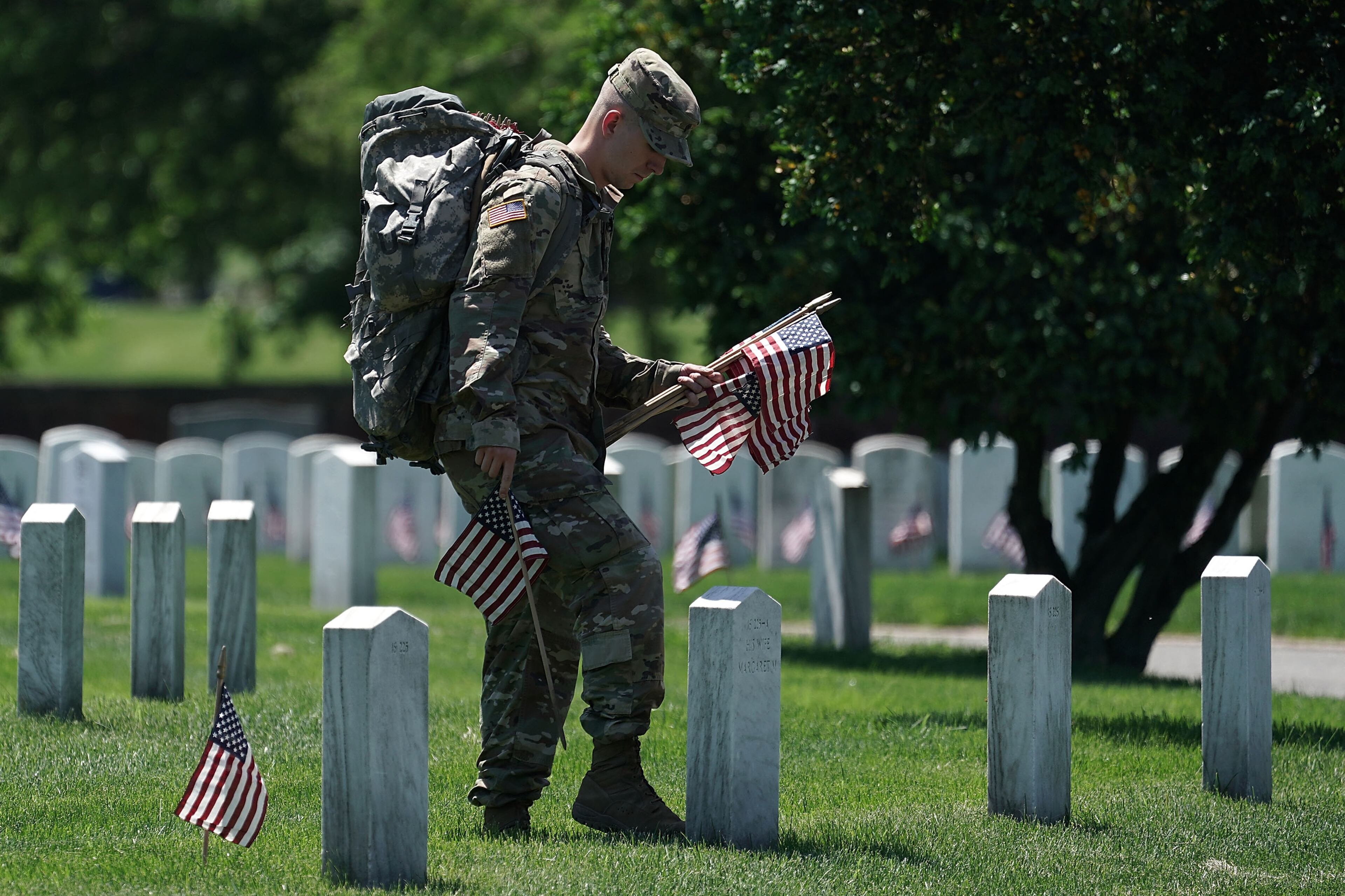 ARLINGTON, VA - MAY 24: A soldier with the U.S. Army 3rd Infantry Regiment (The Old Guard) participates in a "Flags In" event May 24, 2018 at Arlington National Cemetery in Arlington, Virginia. The cemetery hosts the annual event to adorn all cemetery graves with U.S. flags in advance of Memorial Day. (Photo by Alex Wong/Getty Images)