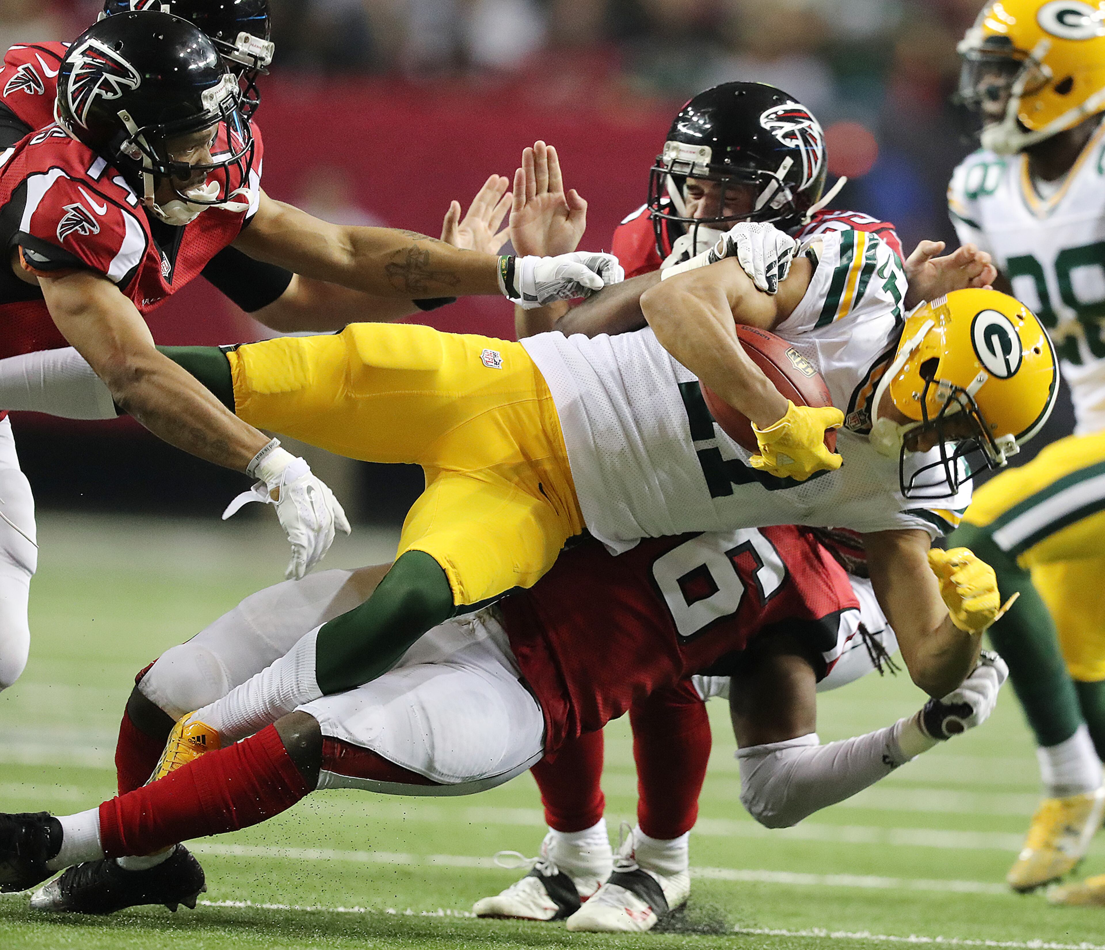 October 30, 2016 ATLANTA: Falcons defenders Eric Weems (left) and Paul Worrilow help level Packers Trevor Davis on a punt return during the second half in an NFL football game on Sunday, Oct. 30, 2016, in Atlanta. Curtis Compton /ccompton@ajc.com