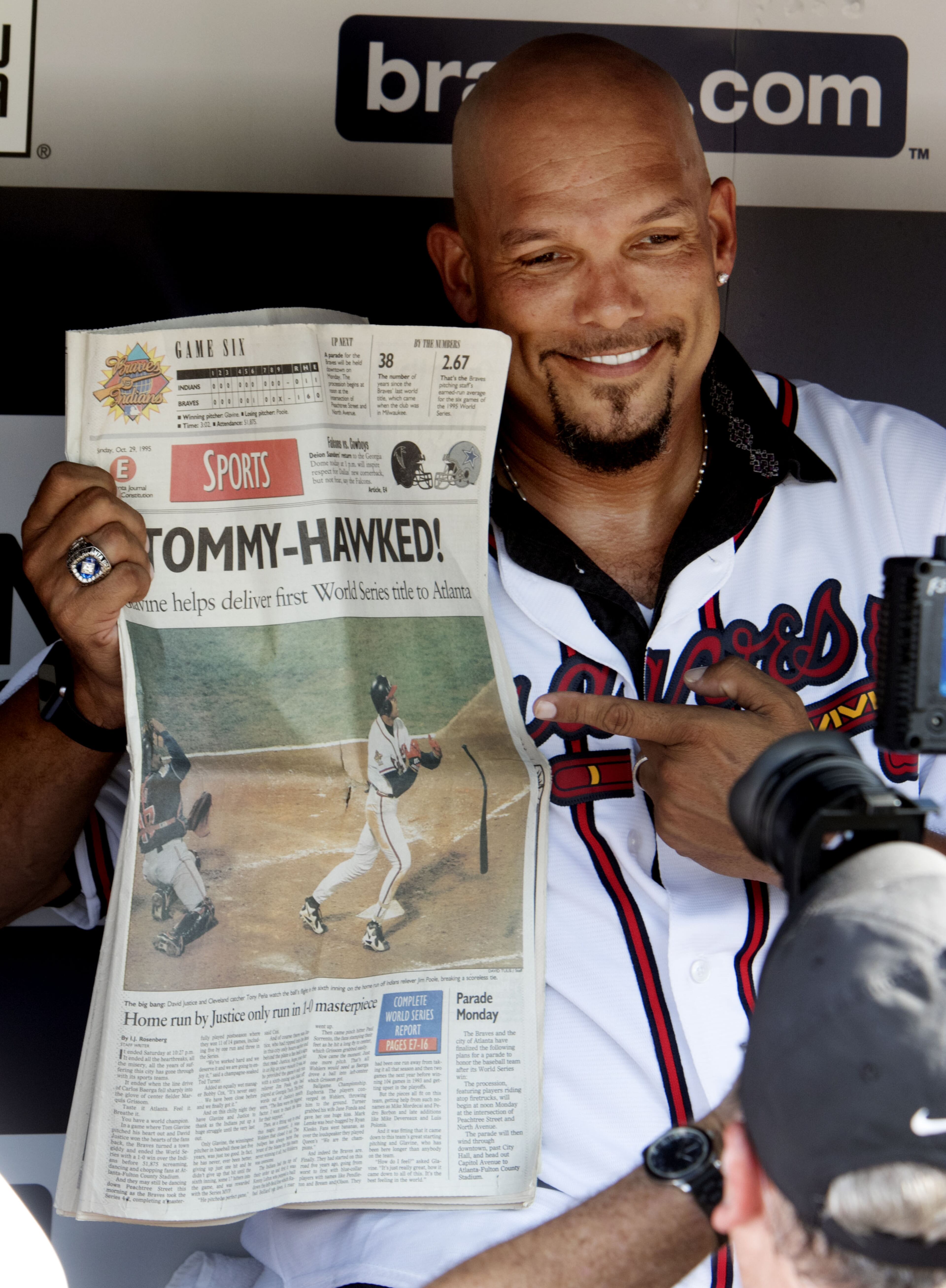 David Justice poses with a newspaper before a softball game with other Braves alumni at Turner Field on August 8th, 2015. (Photo by Phil Skinner)