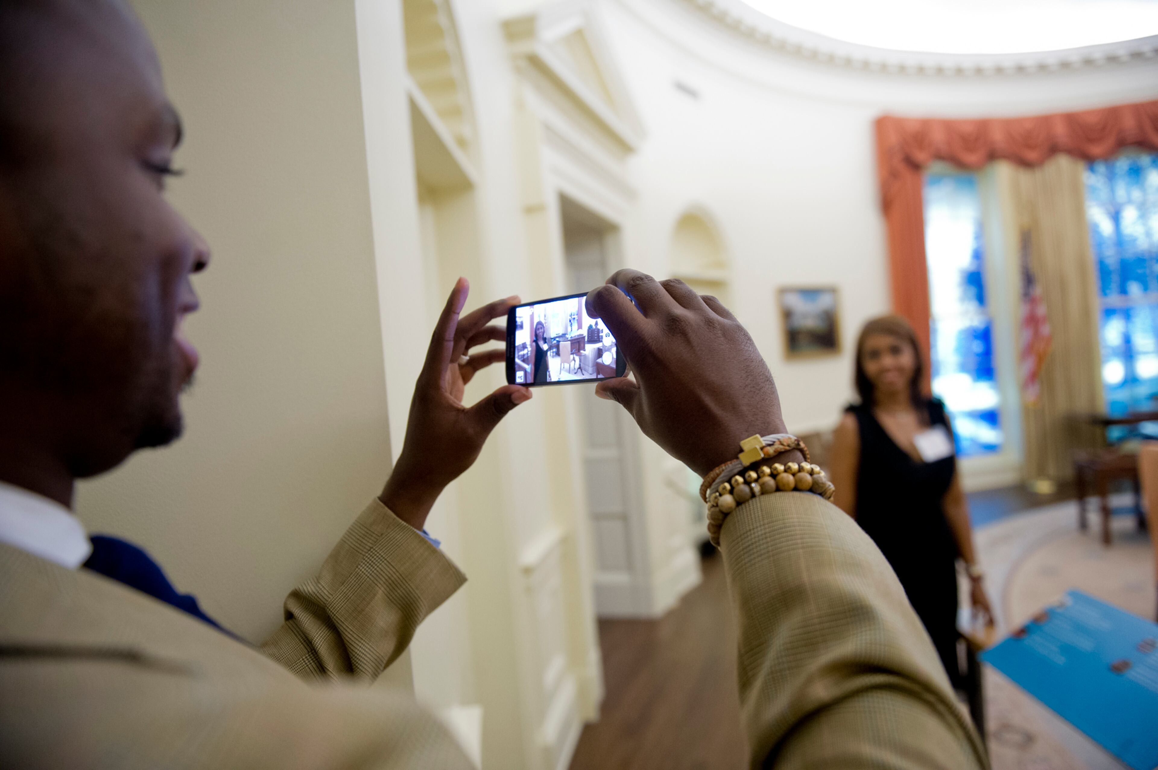 Cynithea Reeder (right) has her photo taken by her husband Jared inside the museum at the Carter Center in Atlanta before the start of America's Sunday Supper on Aug. 11, 2013.