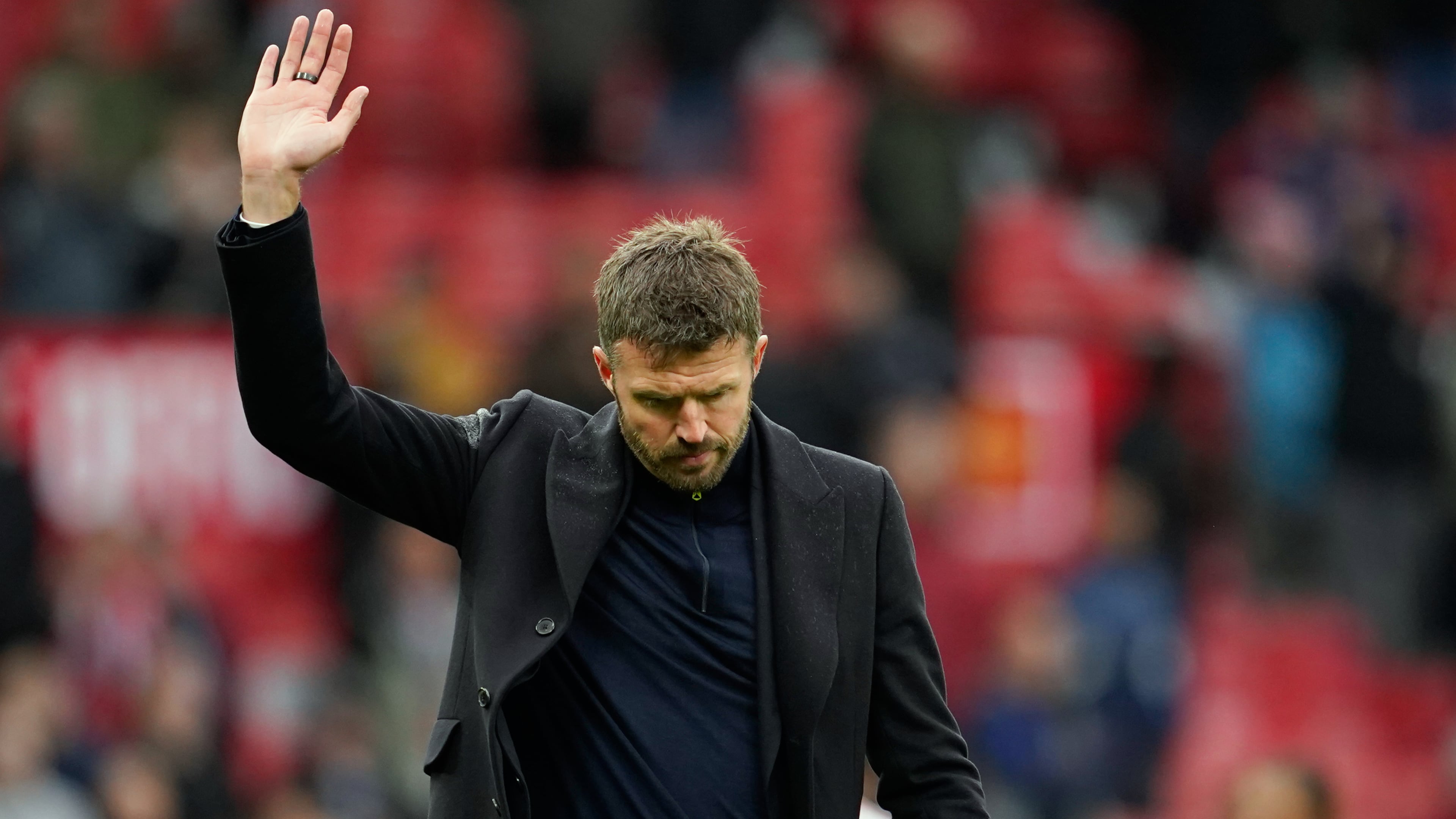 Manchester United's head coach Michael Carrick waves to supporters after his team lost the English Premier League soccer match between Manchester United and Bournemouth in Manchester, England, Sunday, Oct. 25, 2026. (AP Photo/Dave Thompson)