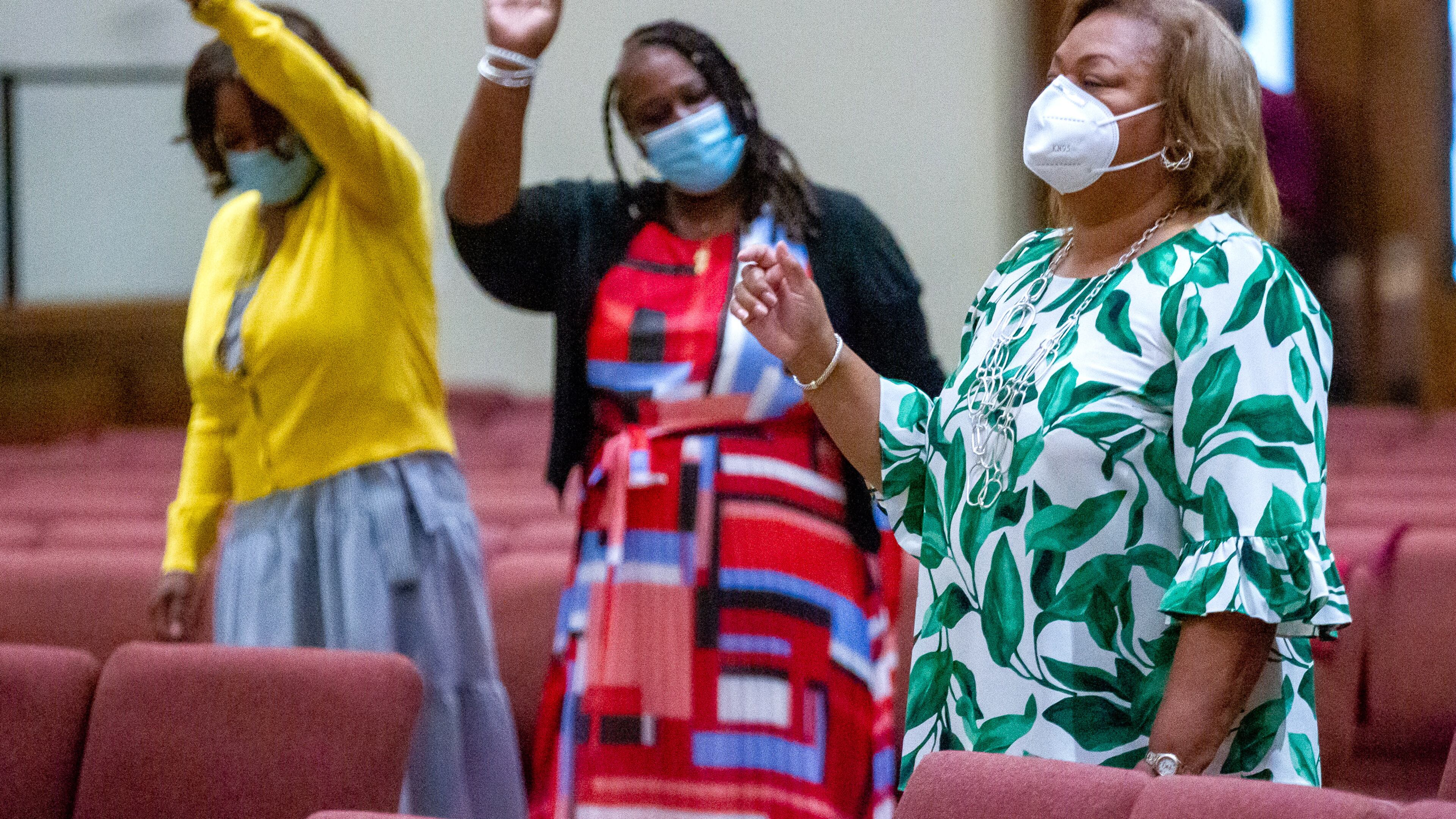 Miranda McKenzie (right) participates in Sunday's service at the Greater Piney Grove Baptist Church in Atlanta on Aug. 29, 2021. (Steve Schaefer for The Atlanta Journal-Constitution)