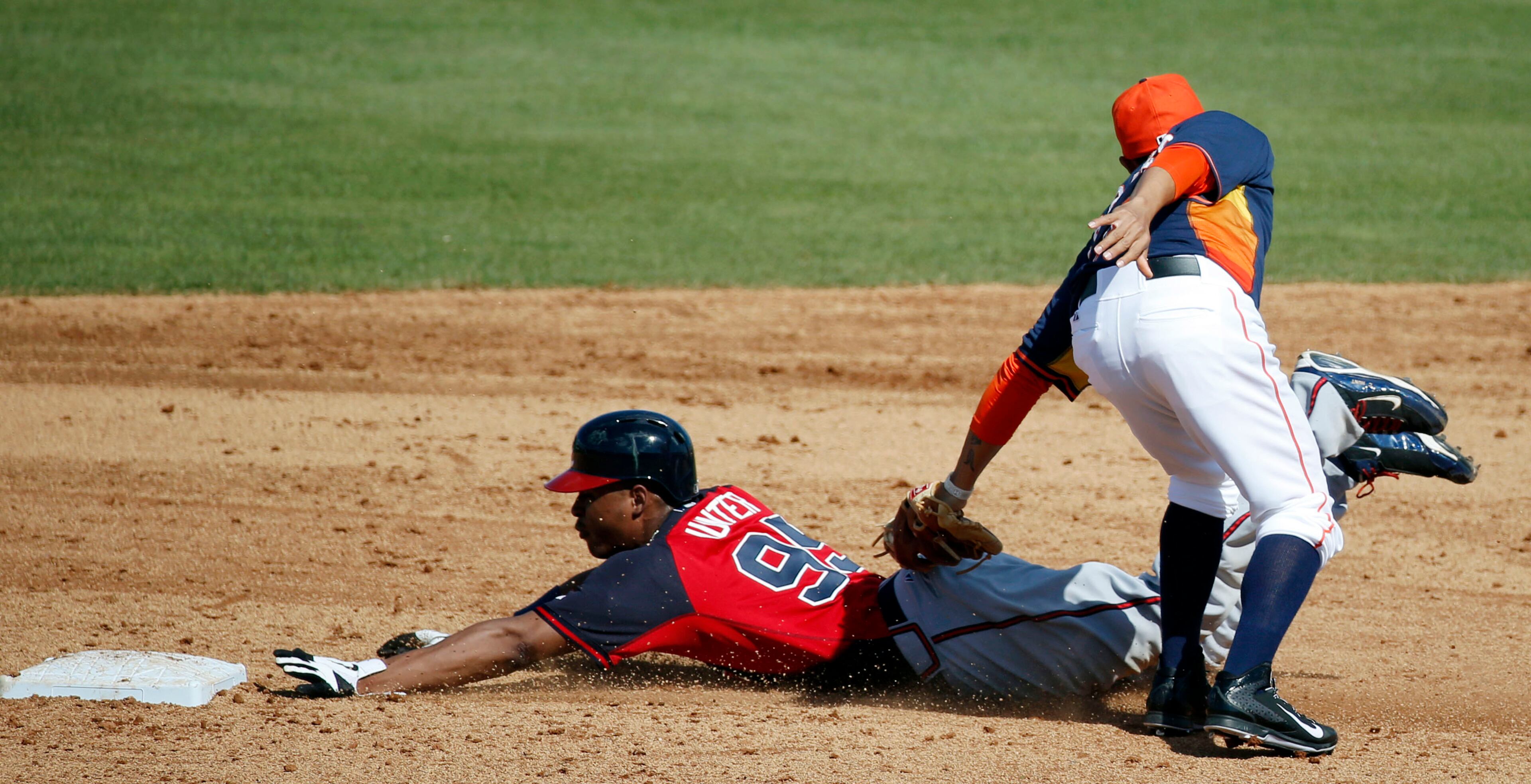 Atlanta Braves' Cedric Hunter is out on the tag at second by Houston Astros second baseman Ronald Torreyes, on a steal attempt in the sixth inning of an exhibition baseball game, Sunday, March 2, 2014, in Kissimmee, Fla. The Astros won 7-4. (AP Photo/Alex Brandon)