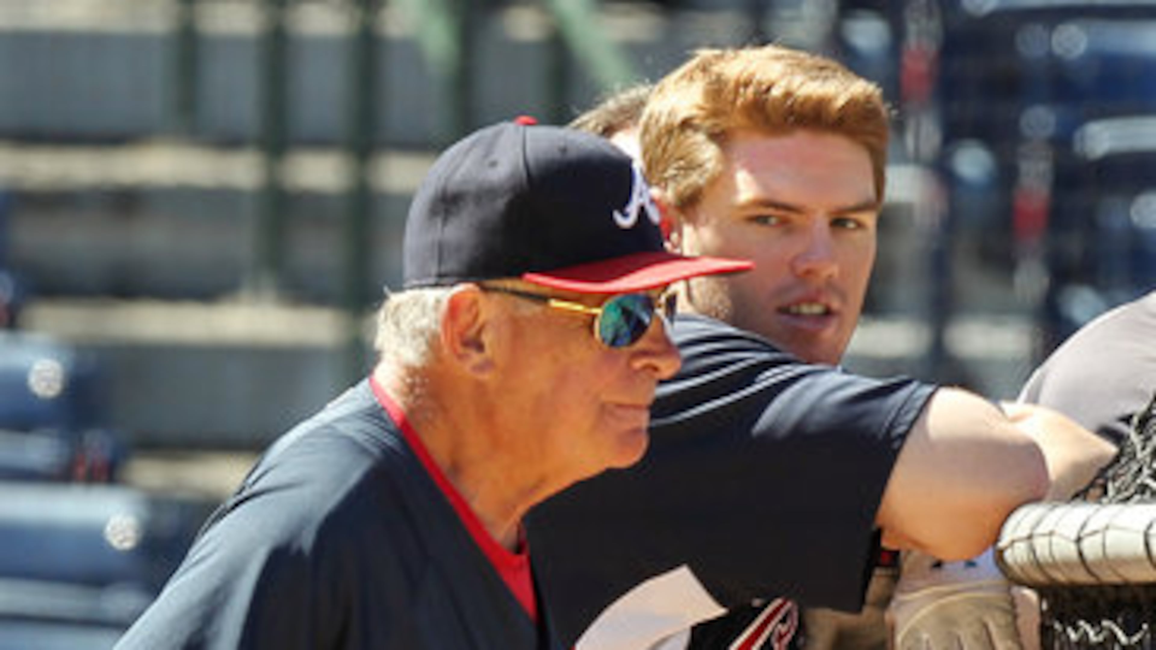 Bobby Cox and rookie Freddie Freeman take in batting practice. (AJC File)