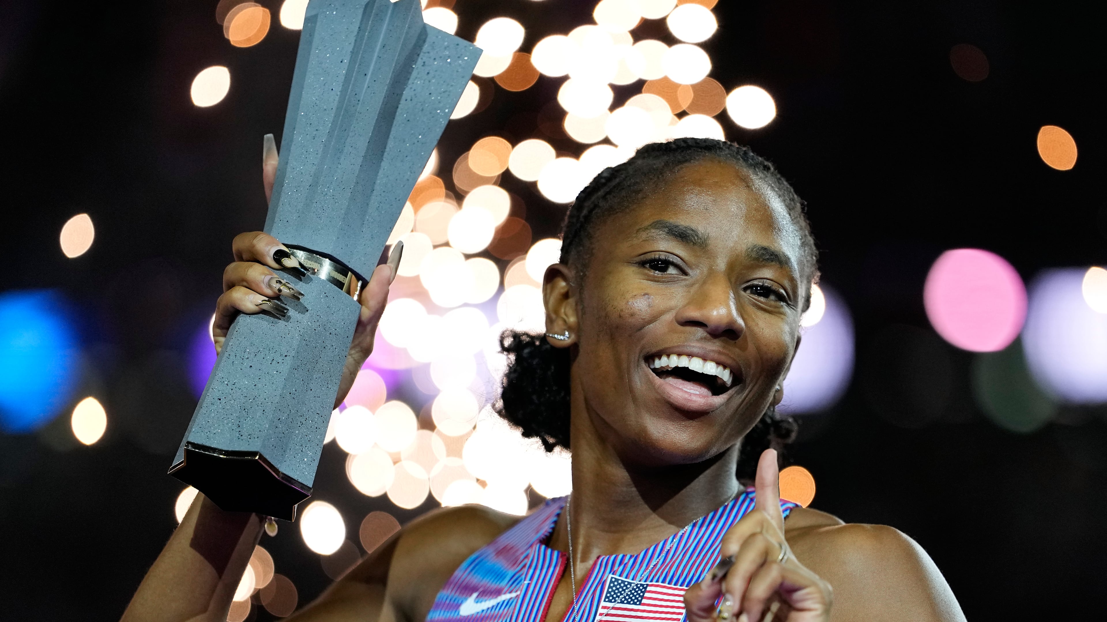 Melissa Jefferson-Wooden, of the United States, poses with her trophy after winning the women's 200 meters final at the World Athletics Ultimate Championship in Budapest, Hungary, Sunday, Sept. 13, 2026. (AP Photo/Matthias Schrader)