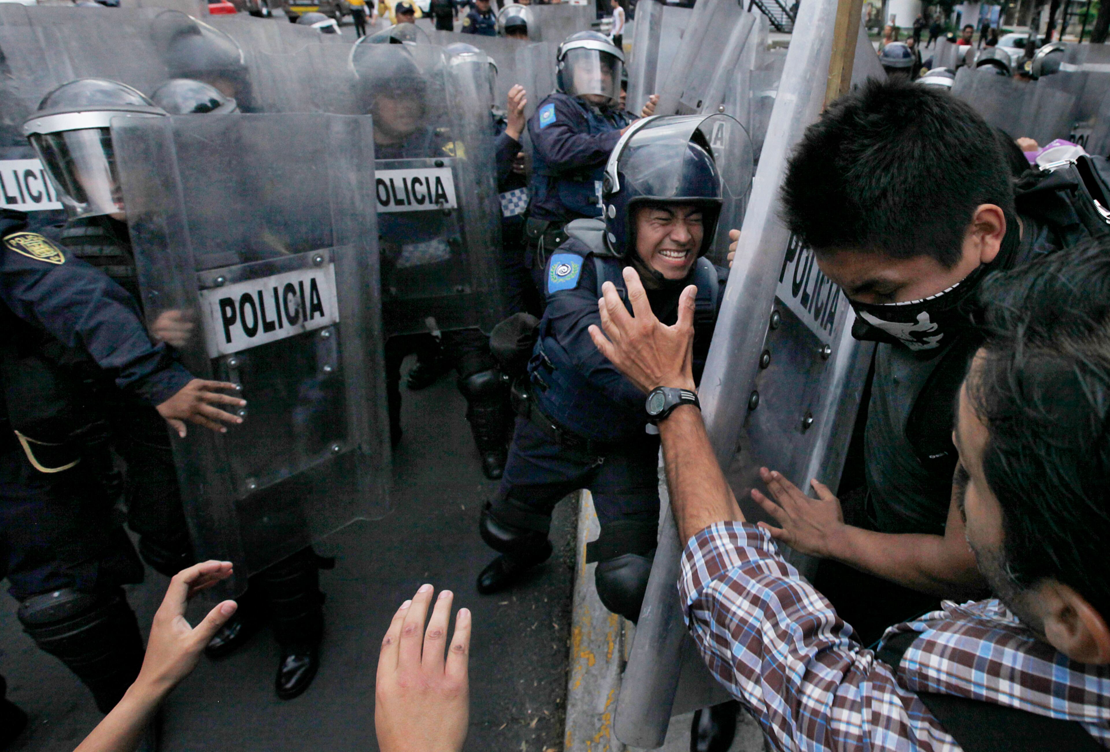 BULLFIGHT PROTEST--Animal rights activists clash with riot police outside the Plaza Mexico bullfighting ring in Mexico City, Sunday, May 29, 2016. The activists are demanding that bullfighting be banned. (AP Photo/Marco Ugarte)