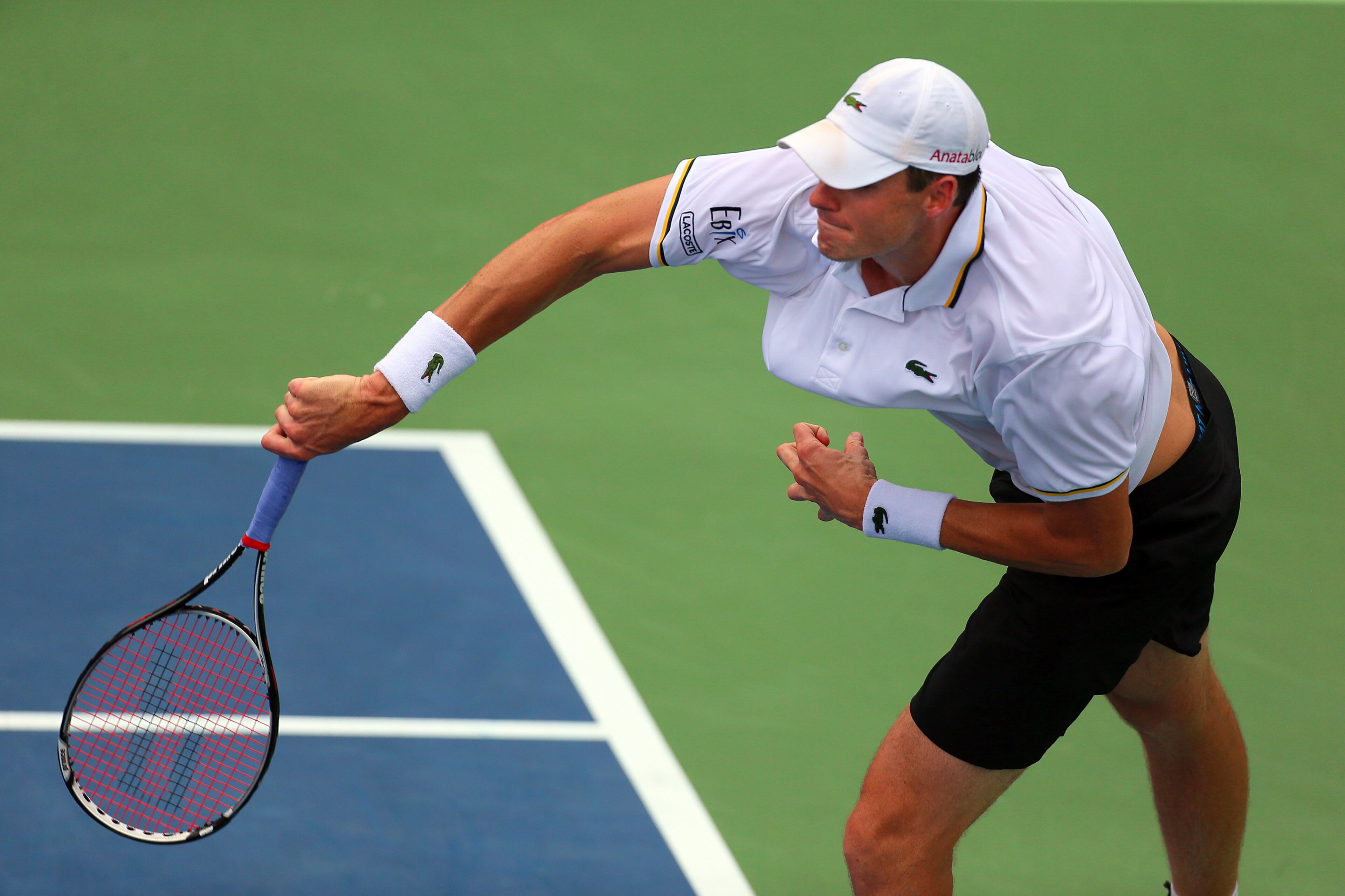 John Isner serves an ace to Kevin Anderson.